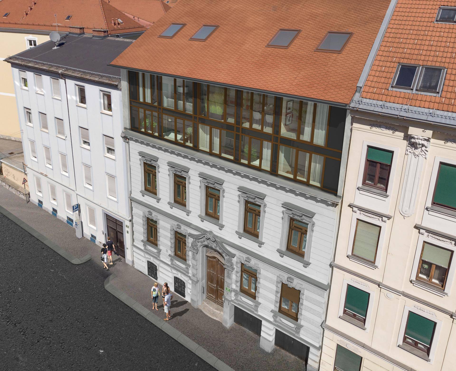 Luftaufnahme der historischen Fassade eines Gebäudes mit Dachgeschossausbau und umliegenden Häusern.