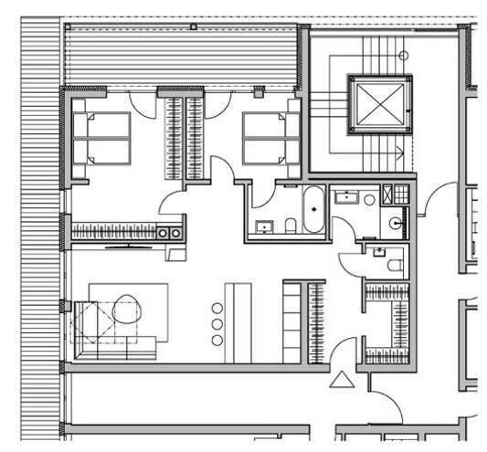 Grundriss einer Wohnung mit zwei Schlafzimmern, offenem Wohnbereich und Balkonzugang.