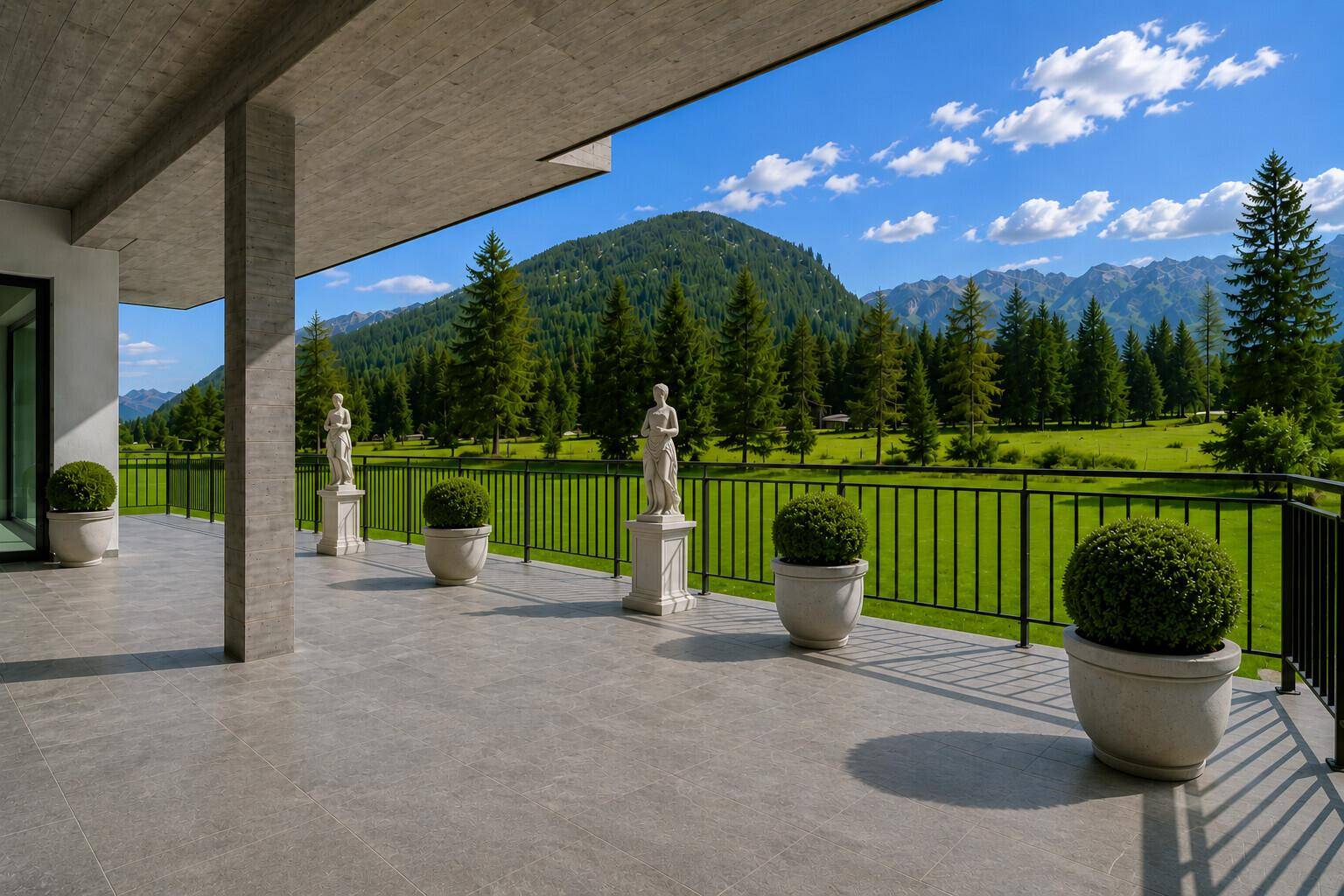 Geräumige Terrasse mit eleganten Statuen und weitem Blick auf die umliegende Berglandschaft.