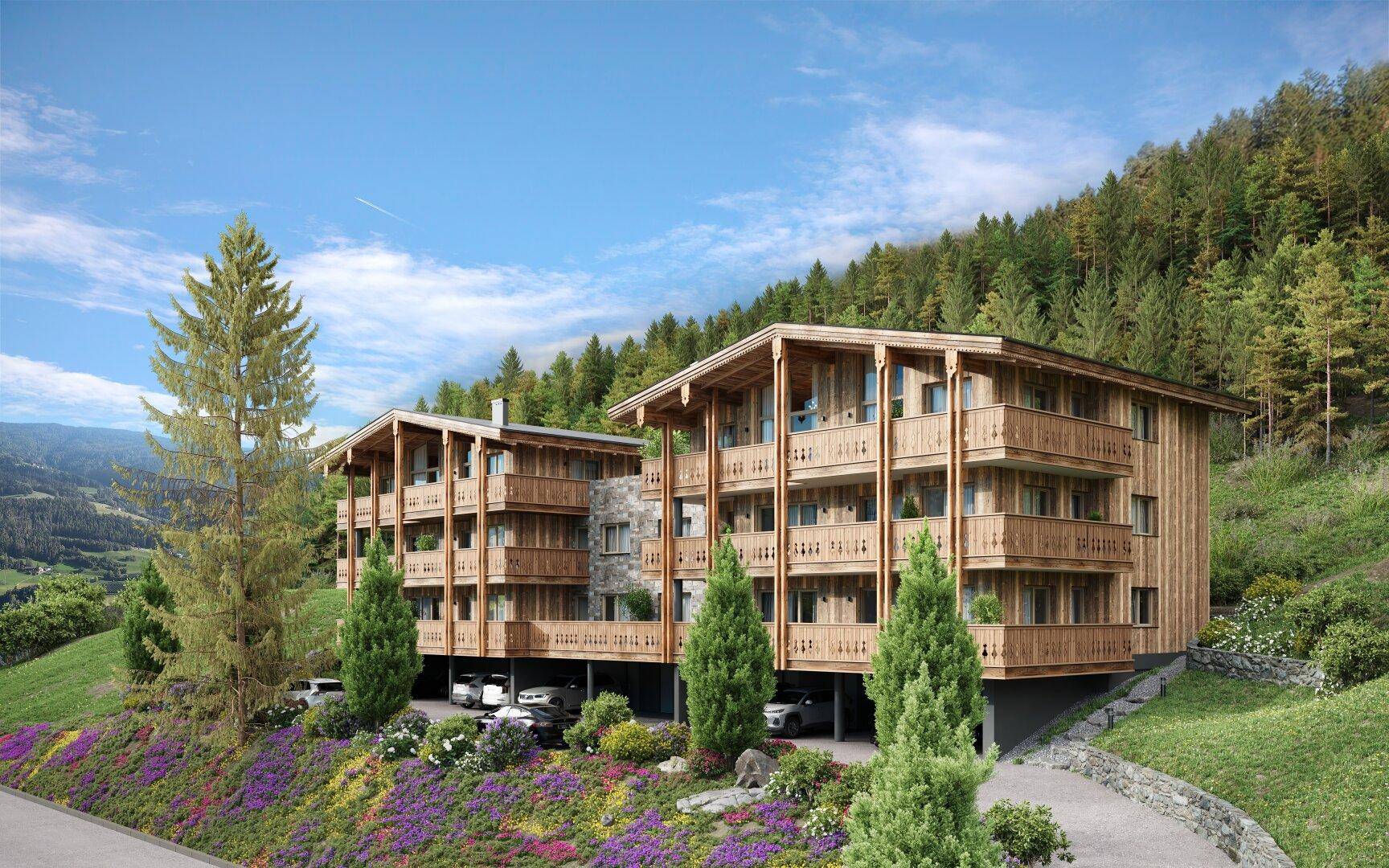 Moderne Chalet-Gebäude in alpiner Umgebung mit Holzbalkonen und umgebender Natur.