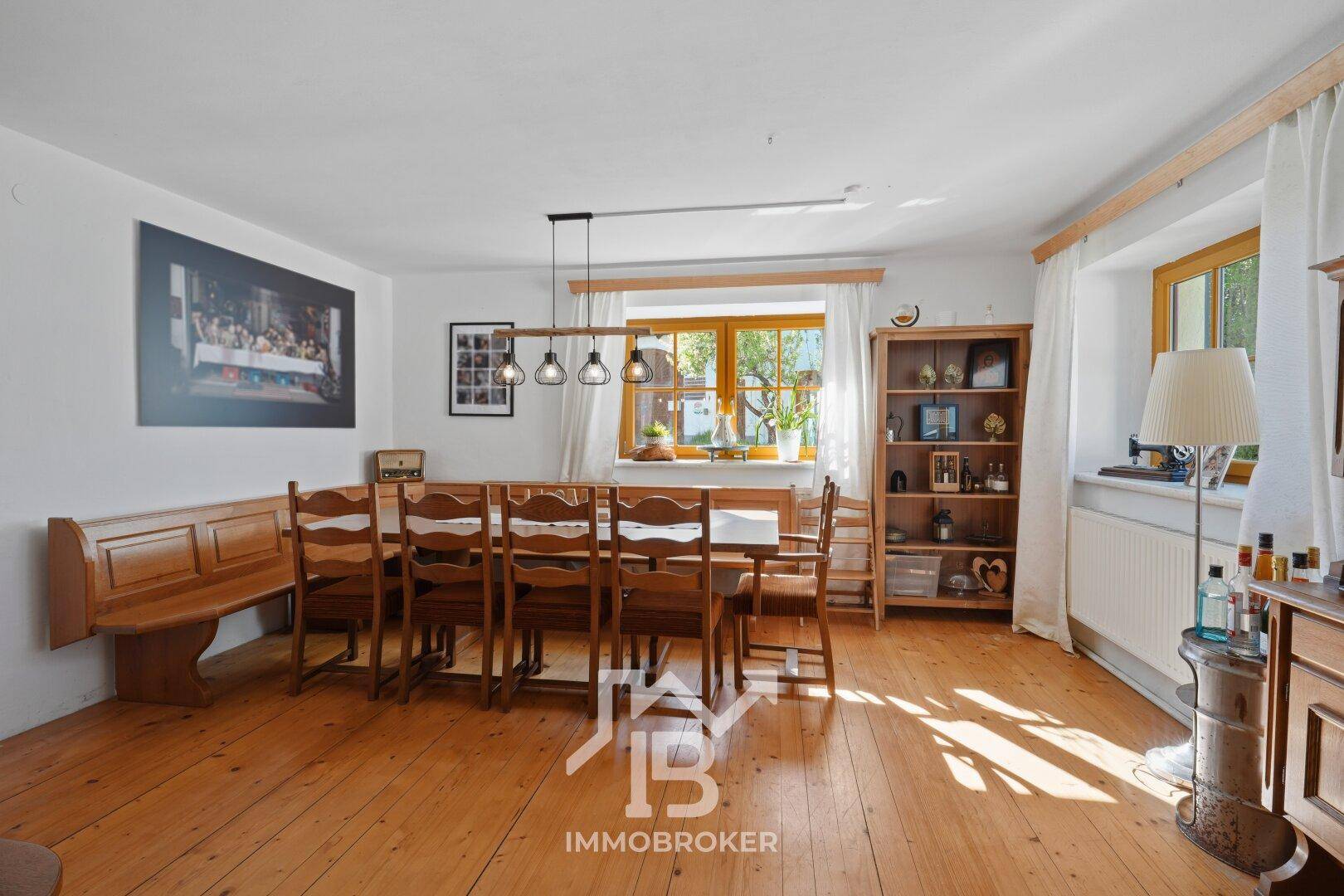 Geräumiges Esszimmer mit großem Holztisch, Bänken und Stühlen, ideal für Familienessen.