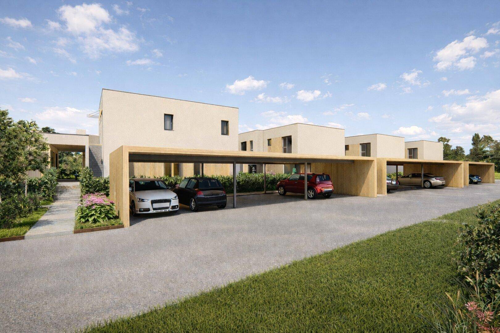 Moderne Reihenhäuser mit integrierten Carports und minimalistischer Architektur unter blauem Himmel.