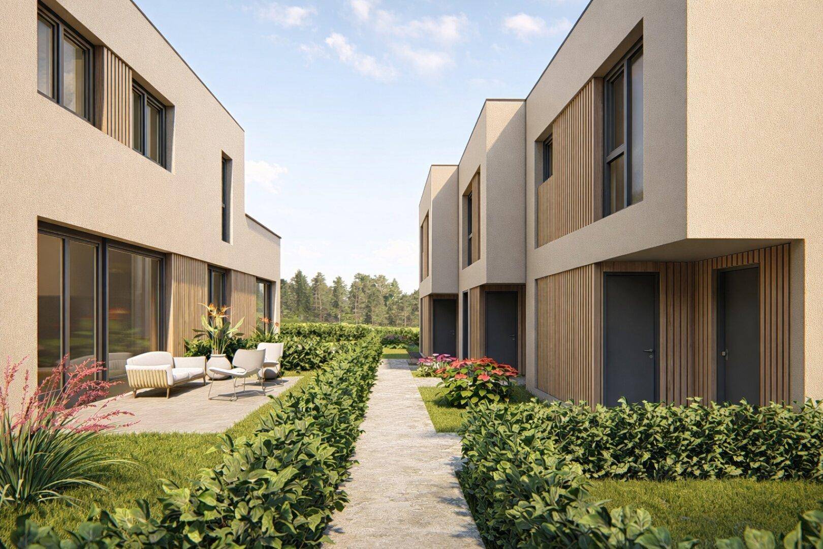 Gepflegte Außenanlage mit modernem Weg, Hecken und Sitzgelegenheiten zwischen den Reihenhäusern.