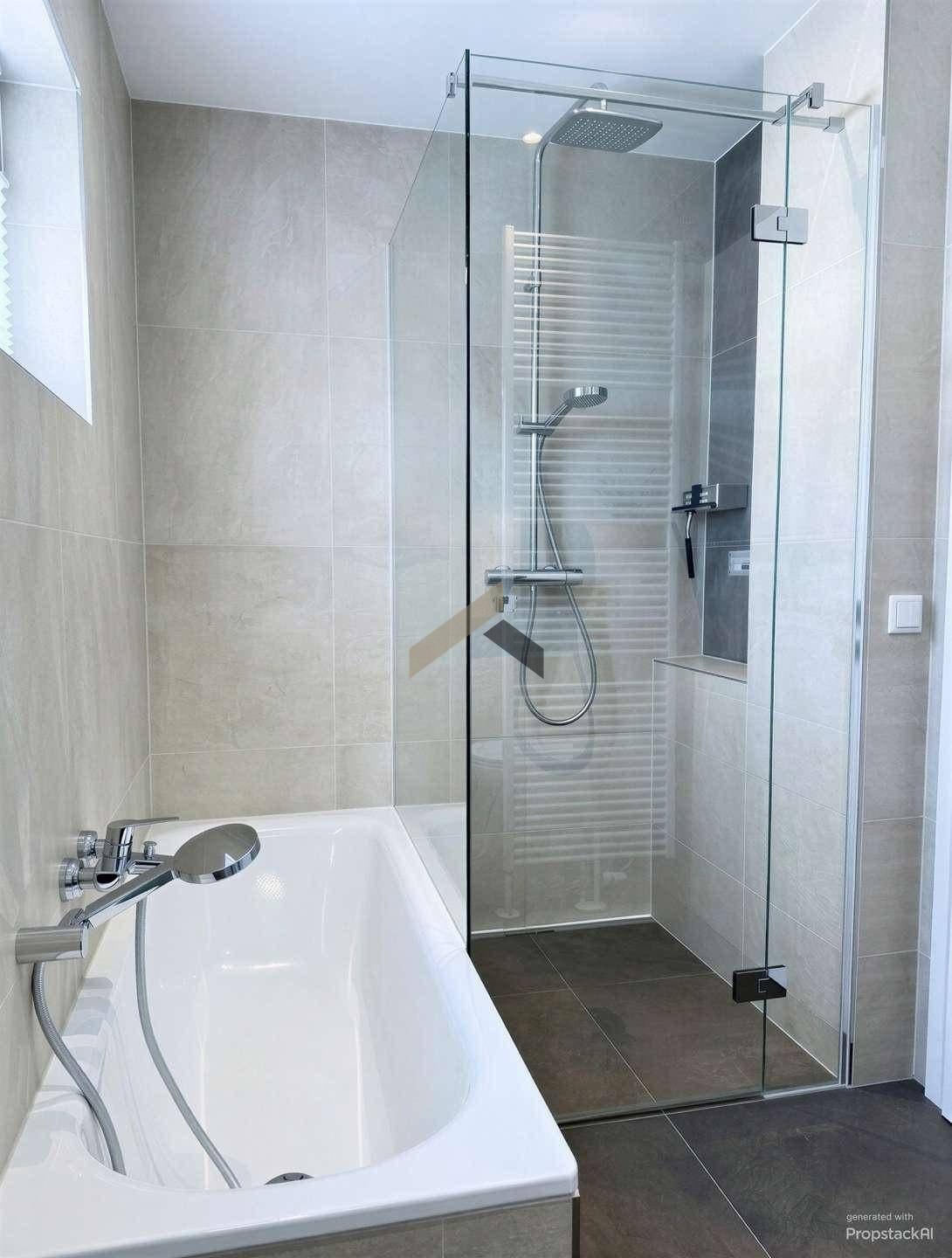 Badezimmer mit Badewanne und moderner begehbarer Dusche mit Glasabtrennung.