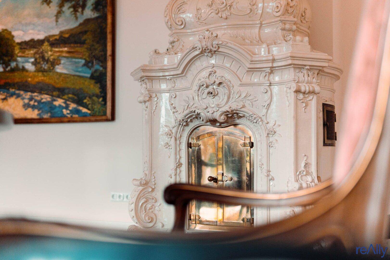 Detailaufnahme eines kunstvoll verzierten Kachelofens, der Wärme und Eleganz spendet.