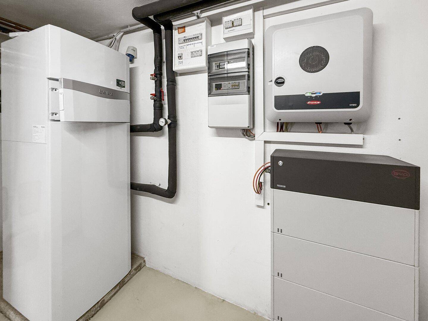 Detailansicht der modernen Heizungsanlage, elektrischer Verteilung und Batteriespeicher im Technikraum.