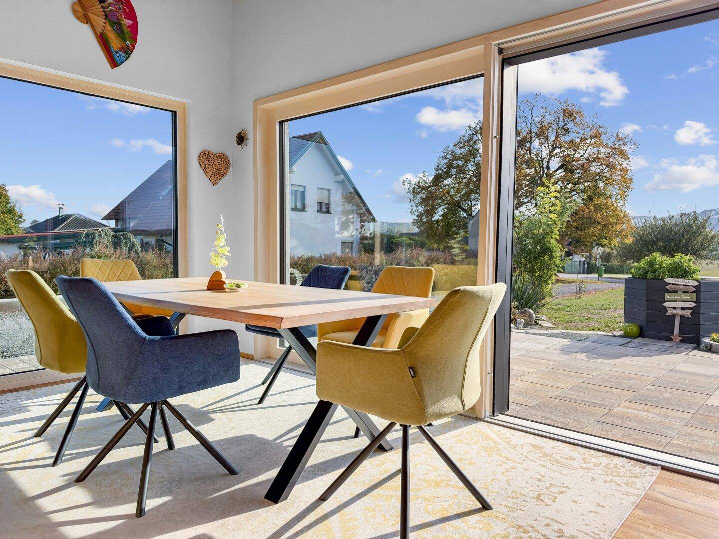 Heller Essbereich mit Zugang zur Terrasse und weitem Blick in die grüne Umgebung.