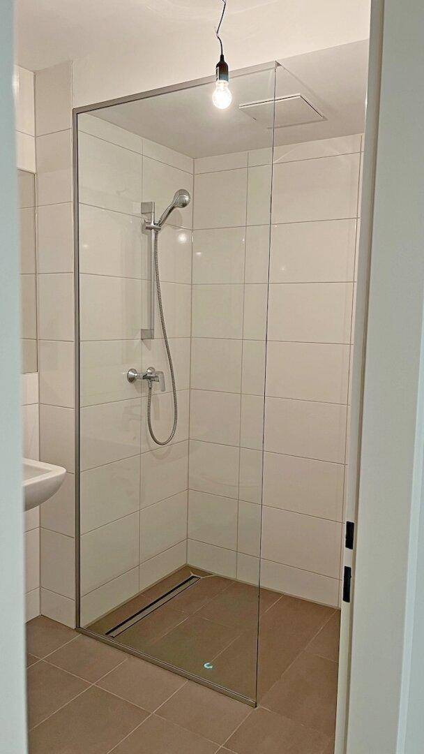 Geräumige Duschkabine mit Glasabtrennung und modernen Fliesen im Badezimmer.