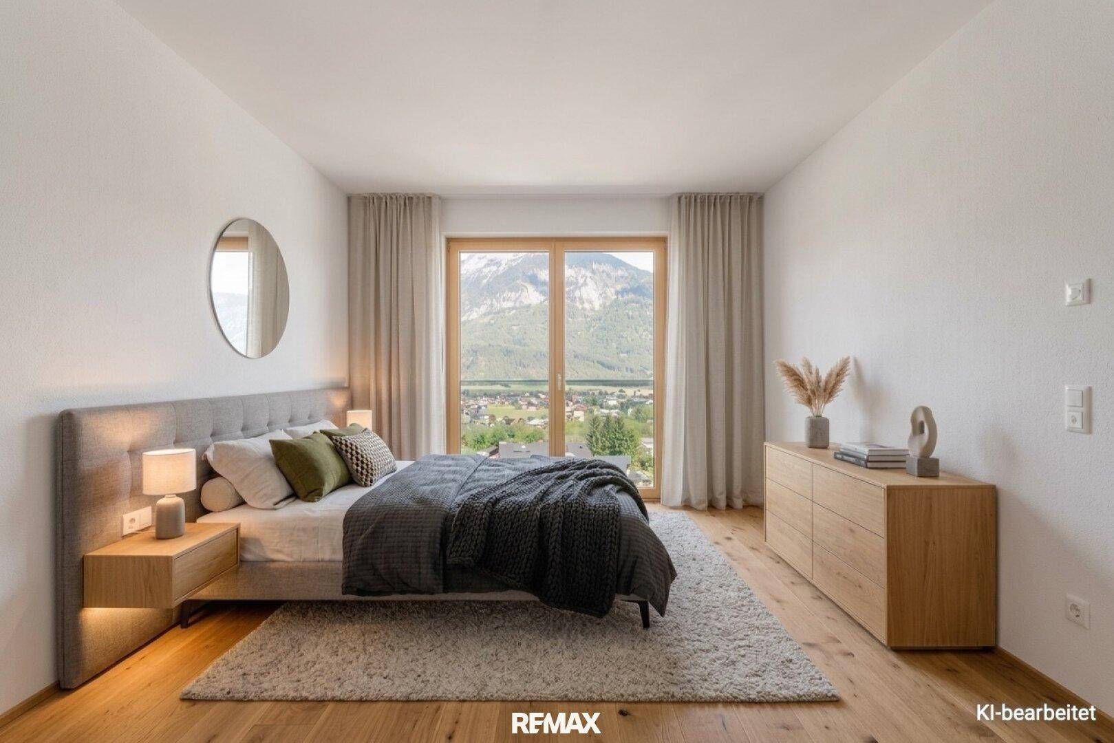 Gemütliches Schlafzimmer mit Holzboden, modernem Bett und direktem Blick auf die Berge.