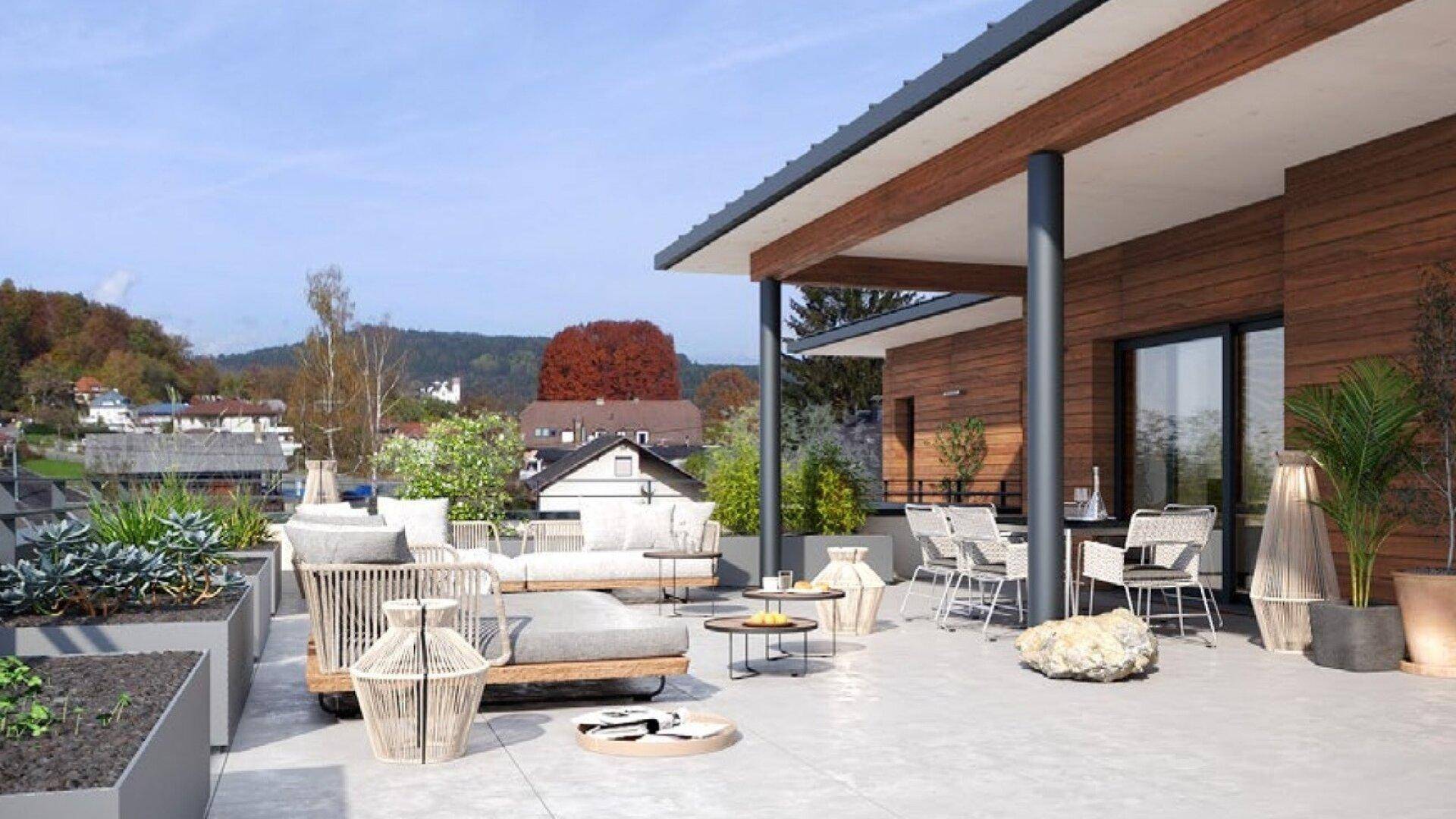 Großzügige Dachterrasse mit stilvollen Loungemöbeln, Pflanzen und weitem Blick über die Umgebung.