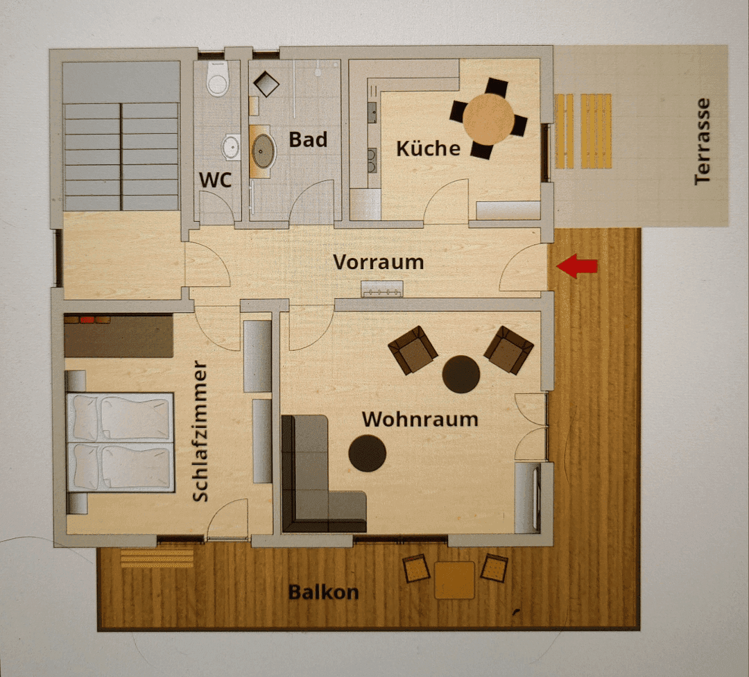 Grundriss einer Wohnung mit Wohnzimmer, Küche, Schlafzimmer, Bad, WC und Balkon.