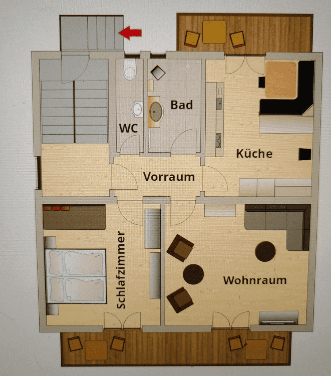 Grundriss einer Wohnung mit Wohnzimmer, Küche, Schlafzimmer, Bad, WC und Balkon.