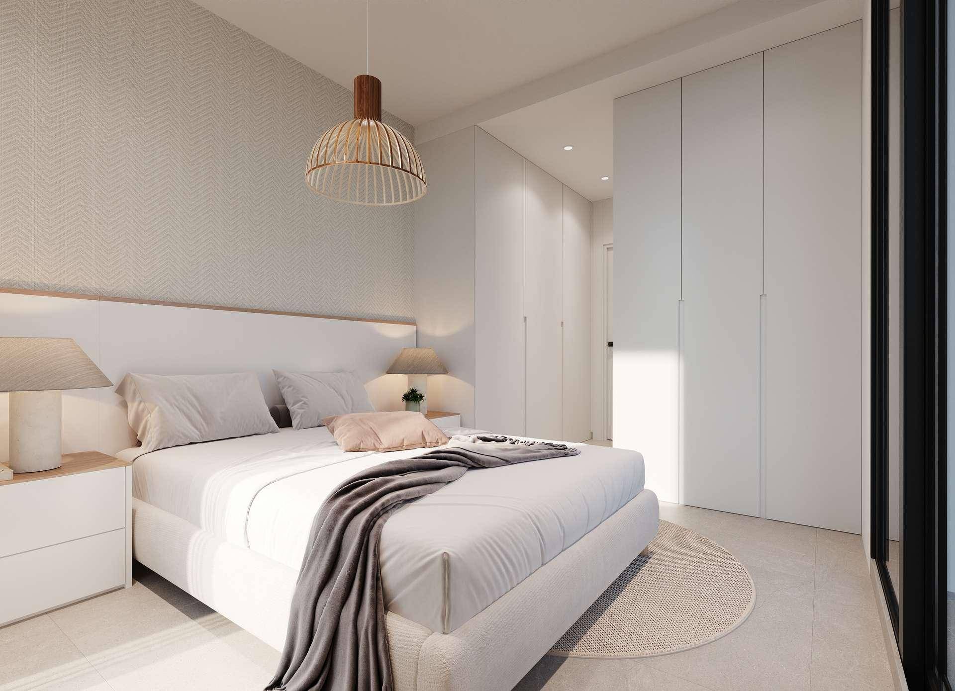 Modernes Schlafzimmer mit großem Bett, integrierten Kleiderschränken und hellem Ambiente durch das Fenster.