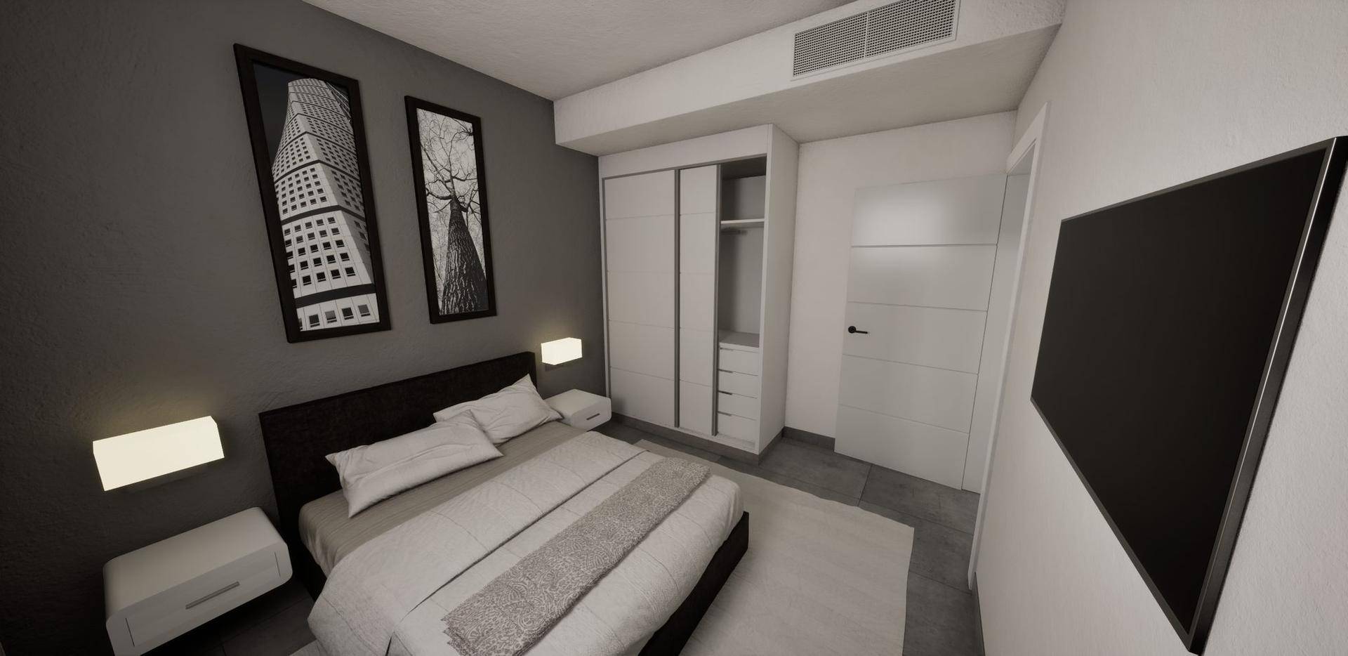 Schlafzimmer mit Doppelbett, Einbauschrank und Blick auf die grüne Landschaft.