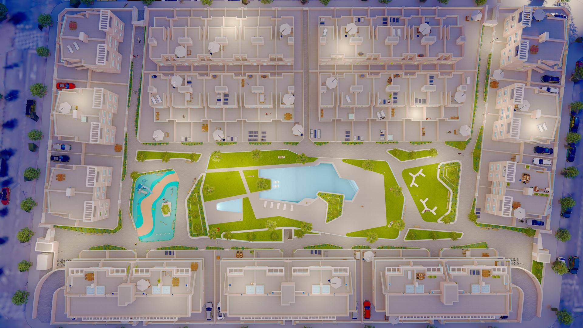 Übersicht des Wohnkomplexes bei Nacht mit beleuchteten Gebäuden, Pools und Grünflächen.