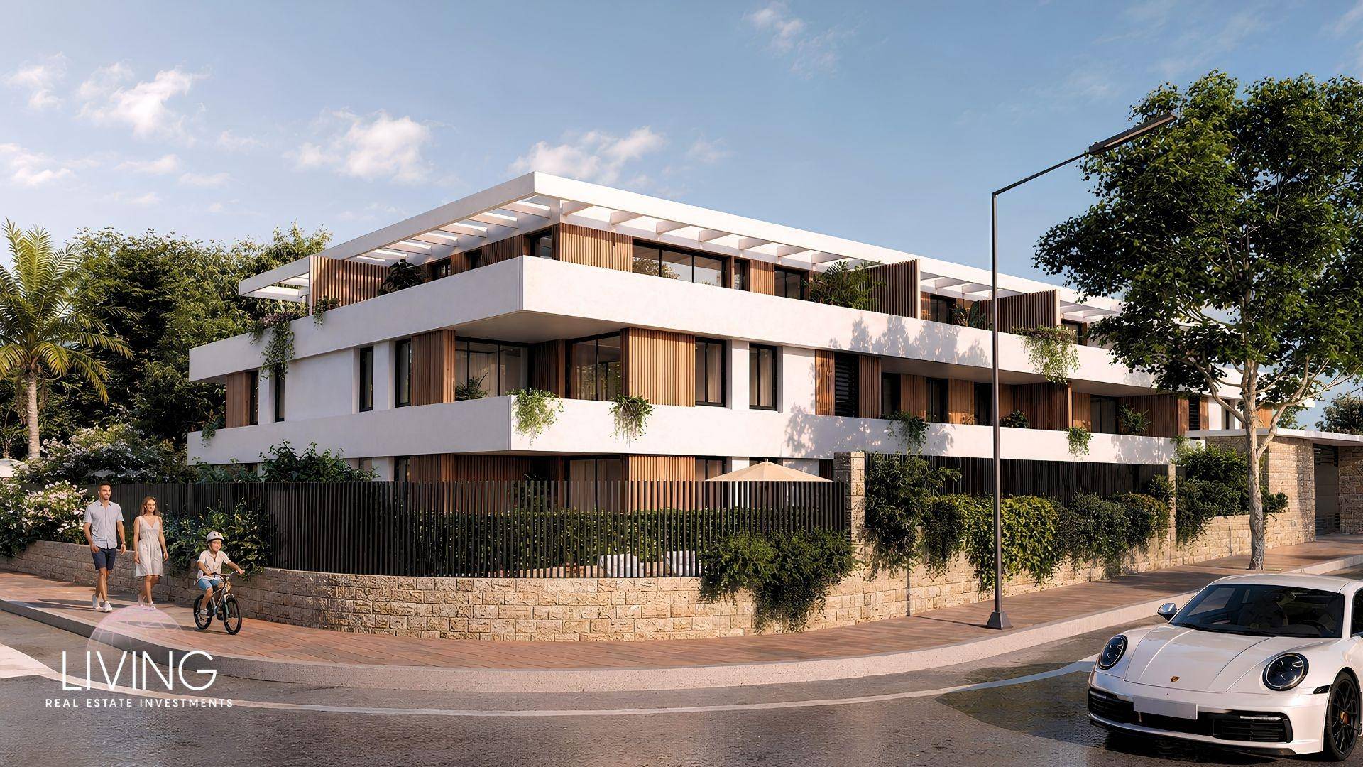 Moderne Wohnanlage von der Straße aus gesehen mit stilvoller Architektur und gepflegter Umgebung.