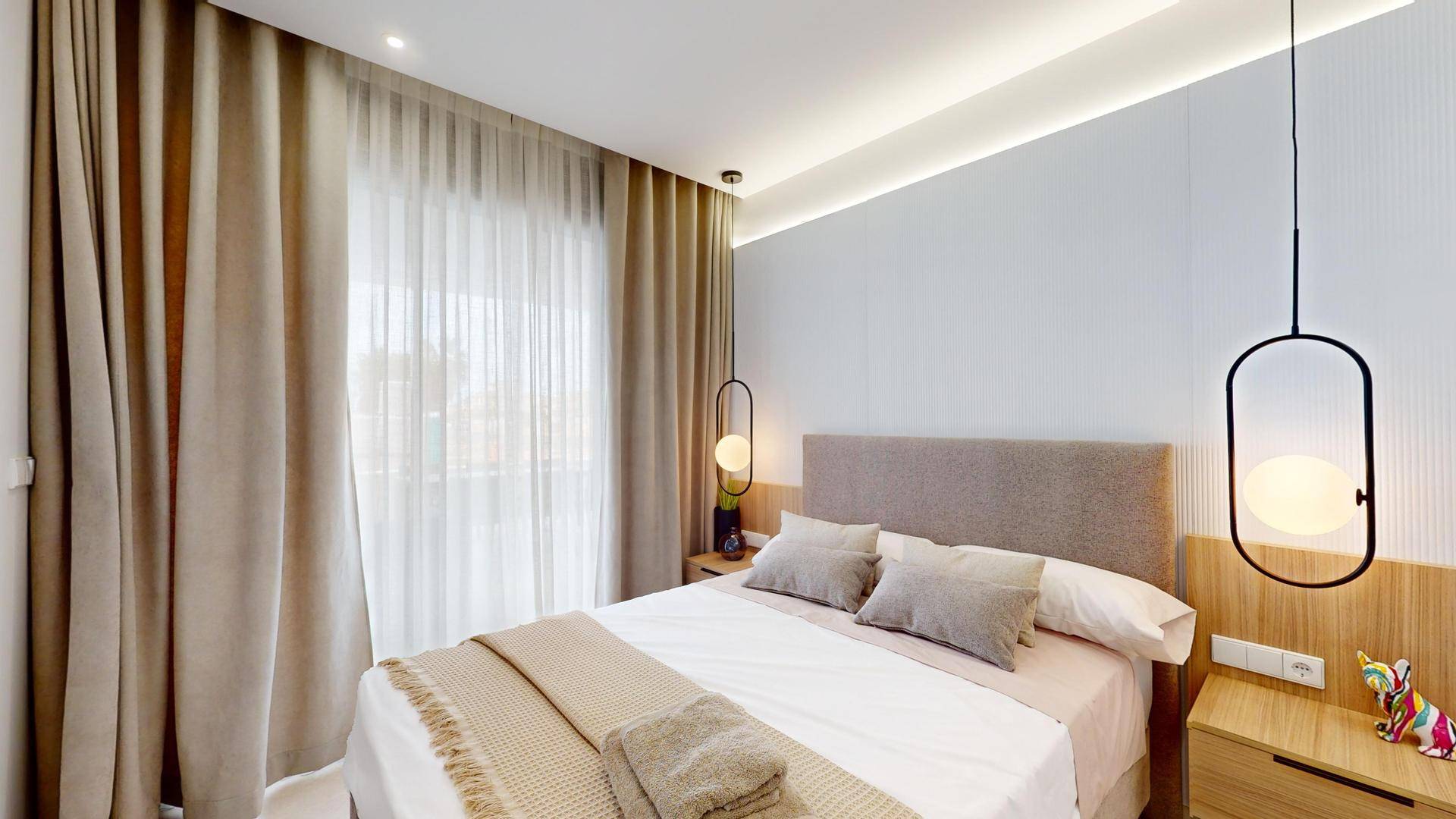 Gemütliches Schlafzimmer mit Doppelbett, Nachttischen und indirekter Beleuchtung.