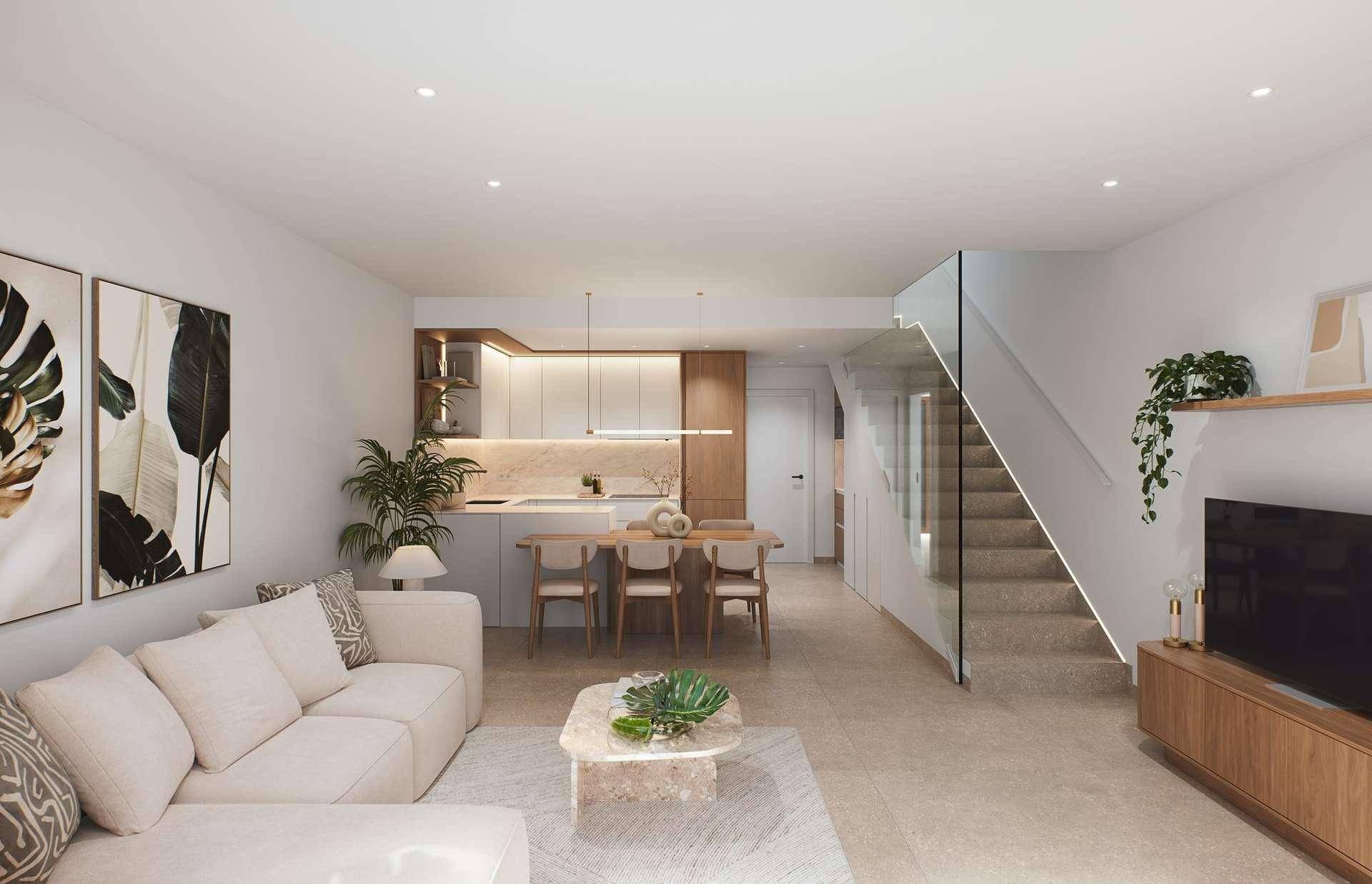 Offener Wohn- und Essbereich mit moderner Küche, beigem Sofa und minimalistischer Einrichtung.