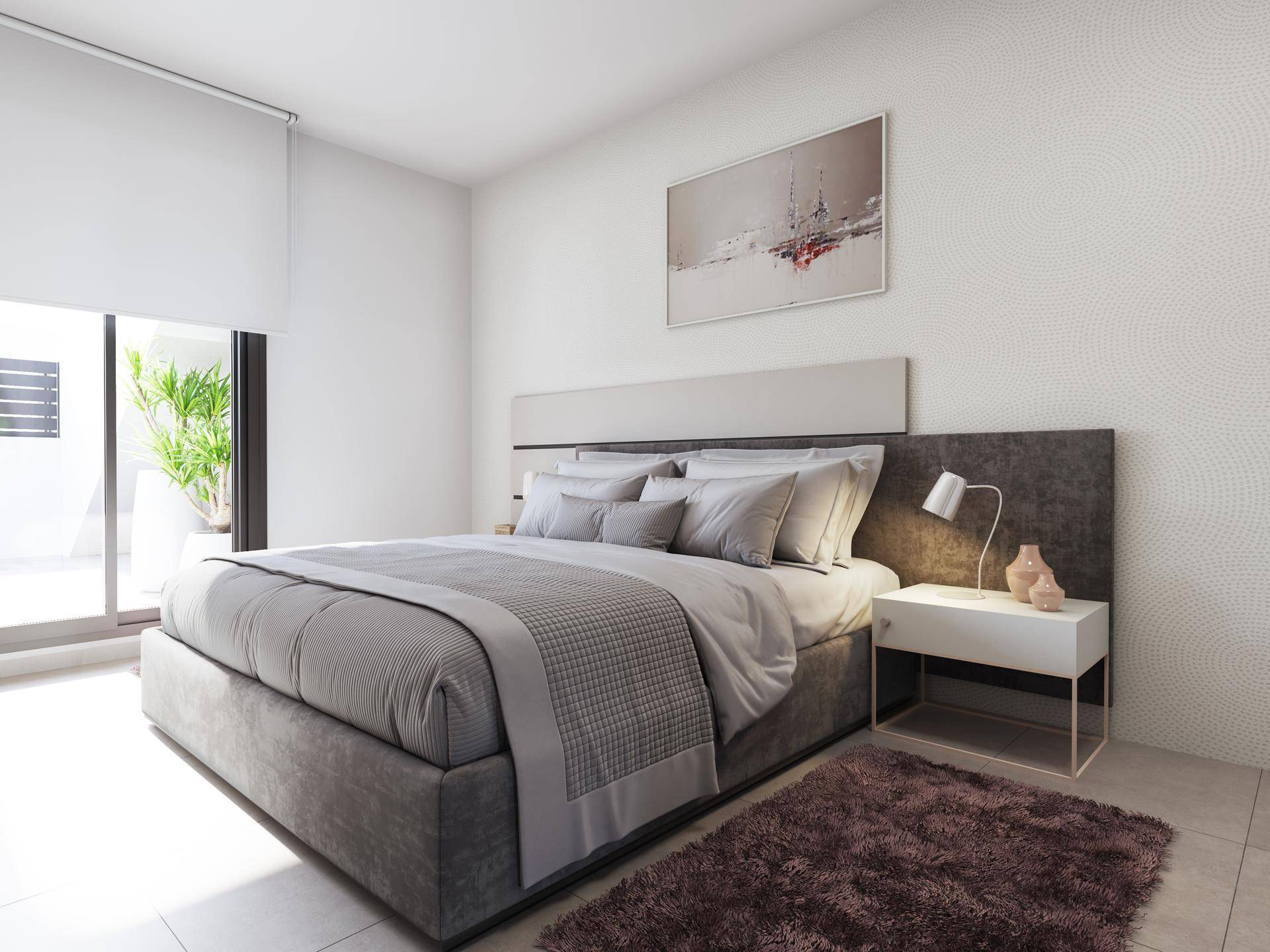 Geräumiges Schlafzimmer mit großem Bett, modernem Design und Zugang zur Terrasse.