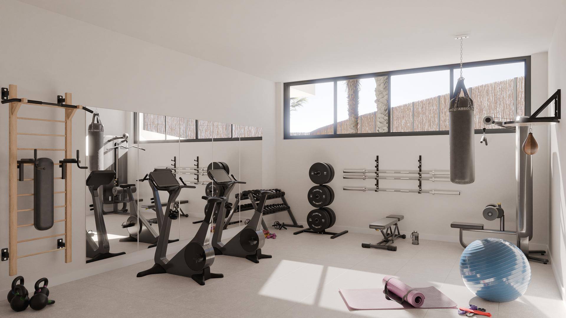 Heller Fitnessraum mit verschiedenen Trainingsgeräten, Spiegeln und großen Fenstern.
