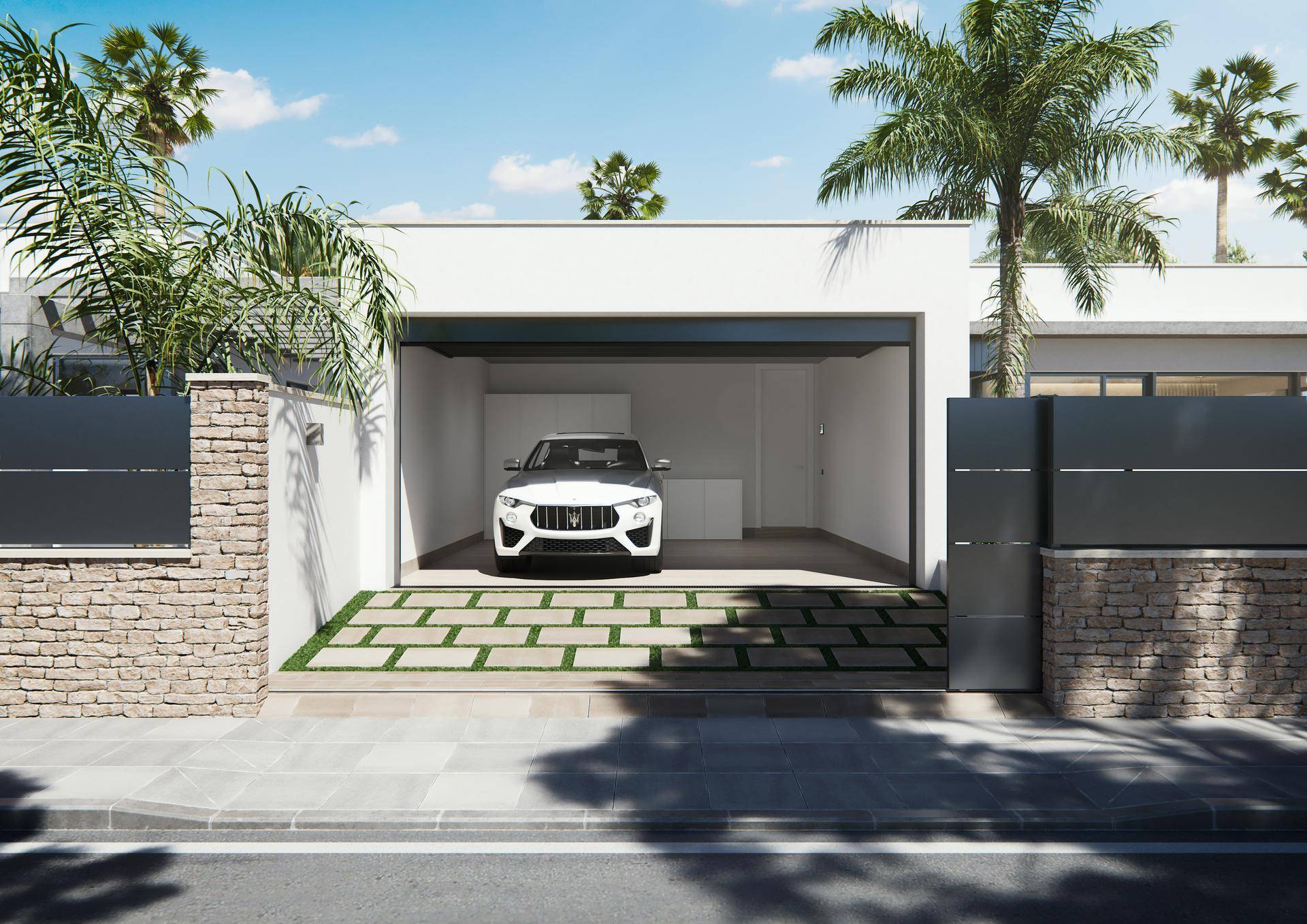 Moderne Garage mit Einfahrt und einem geparkten Auto, umgeben von einer Steinmauer.