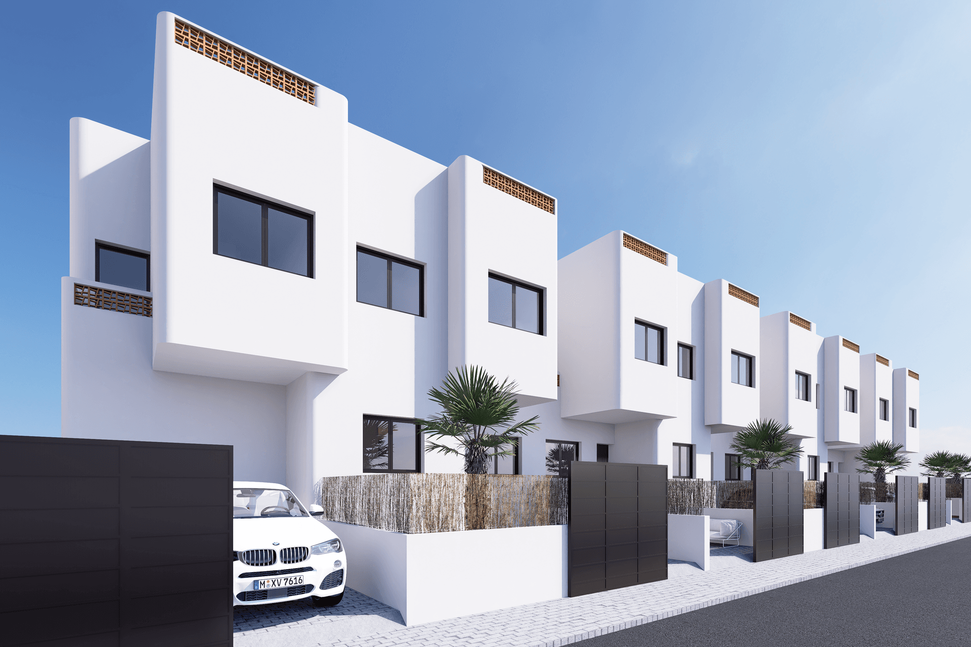 Reihe moderner Häuser mit weißer Fassade, dunklen Fenstern und privaten Einfahrten.