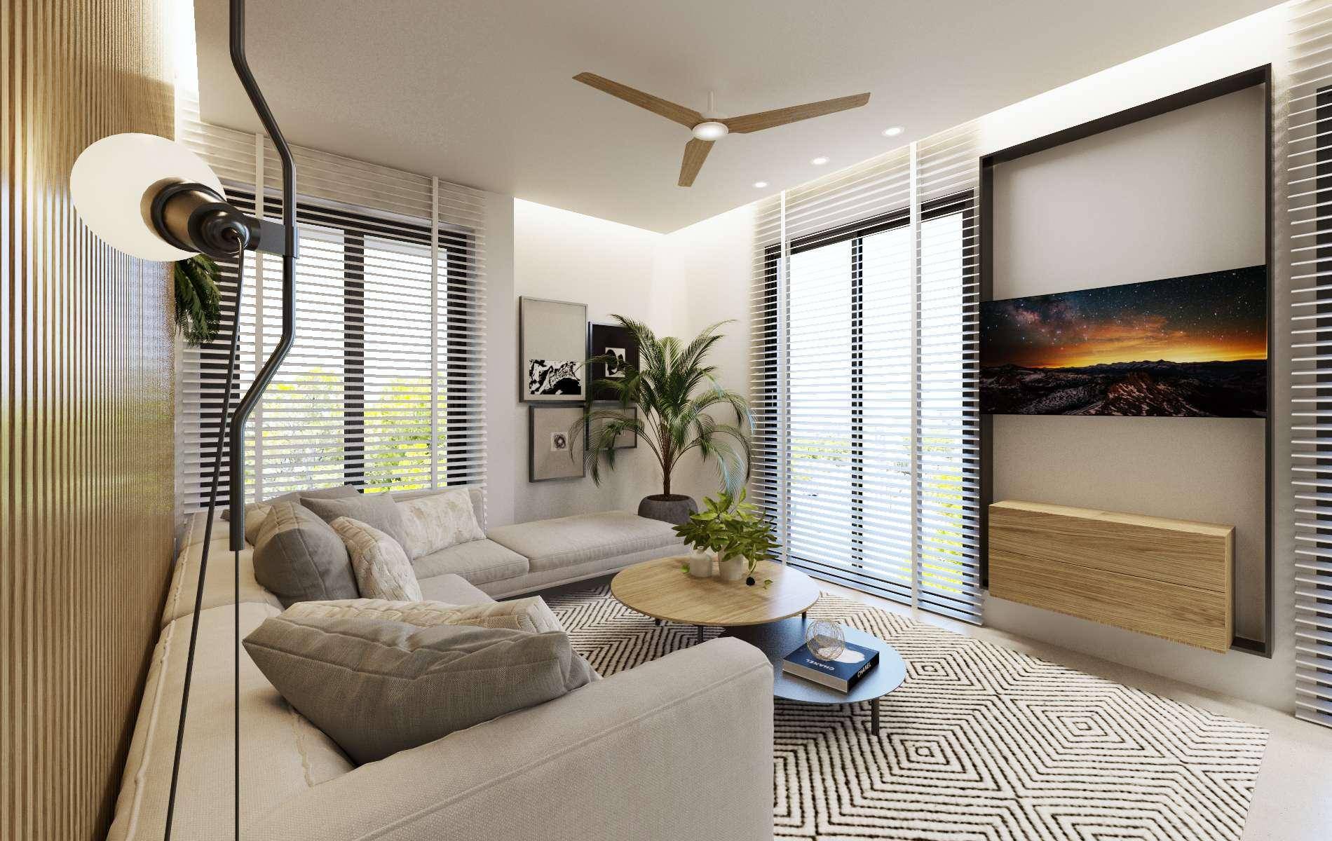 Helles Wohnzimmer mit bequemen Sofas, Deckenventilator und großen Fenstern.