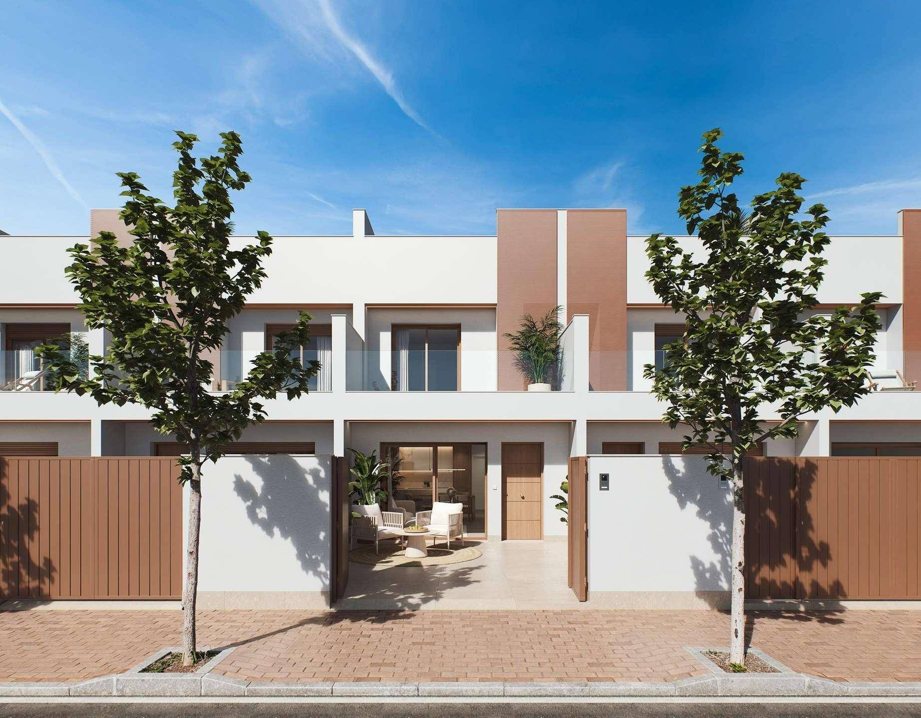 Eingangsbereich eines Reihenhauses mit kleiner, möblierter Terrasse und modernen Pflanzenkübeln.