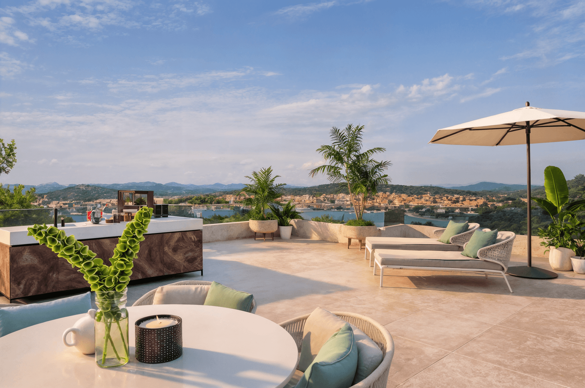 Weitläufige Dachterrasse mit Meerblick, Lounge-Möbeln und Außenküche unter blauem Himmel.