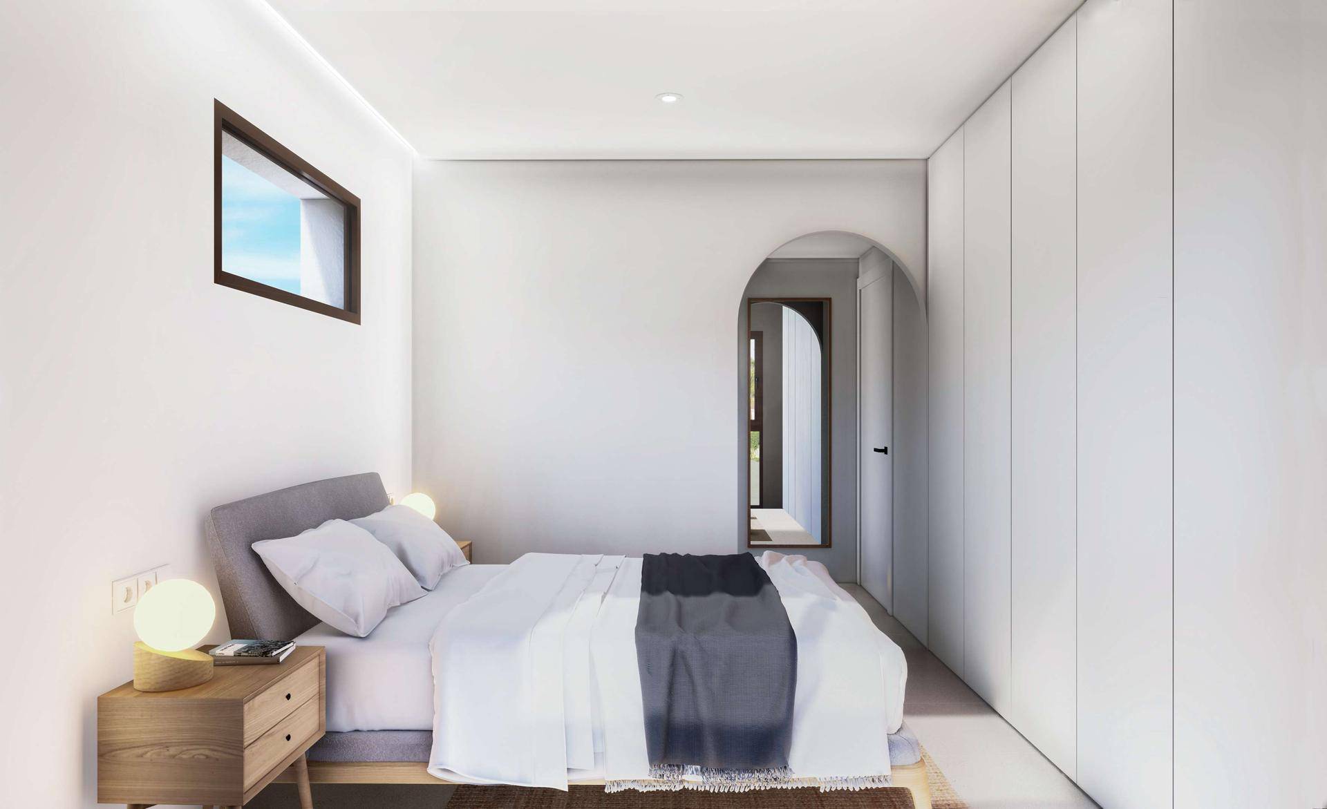 Schlafzimmer mit integrierten Schränken und Zugang zu einem weiteren Raum.