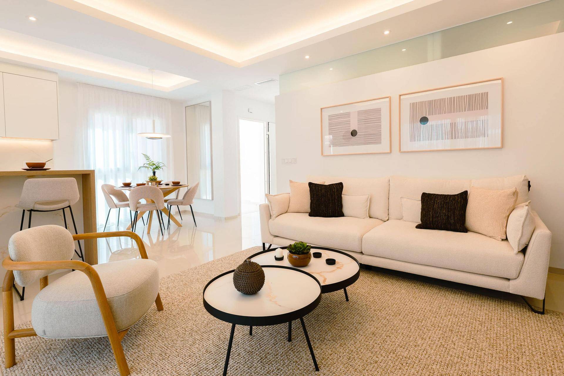 Heller offener Wohn- und Essbereich mit bequemen Sofas und moderner Dekoration.
