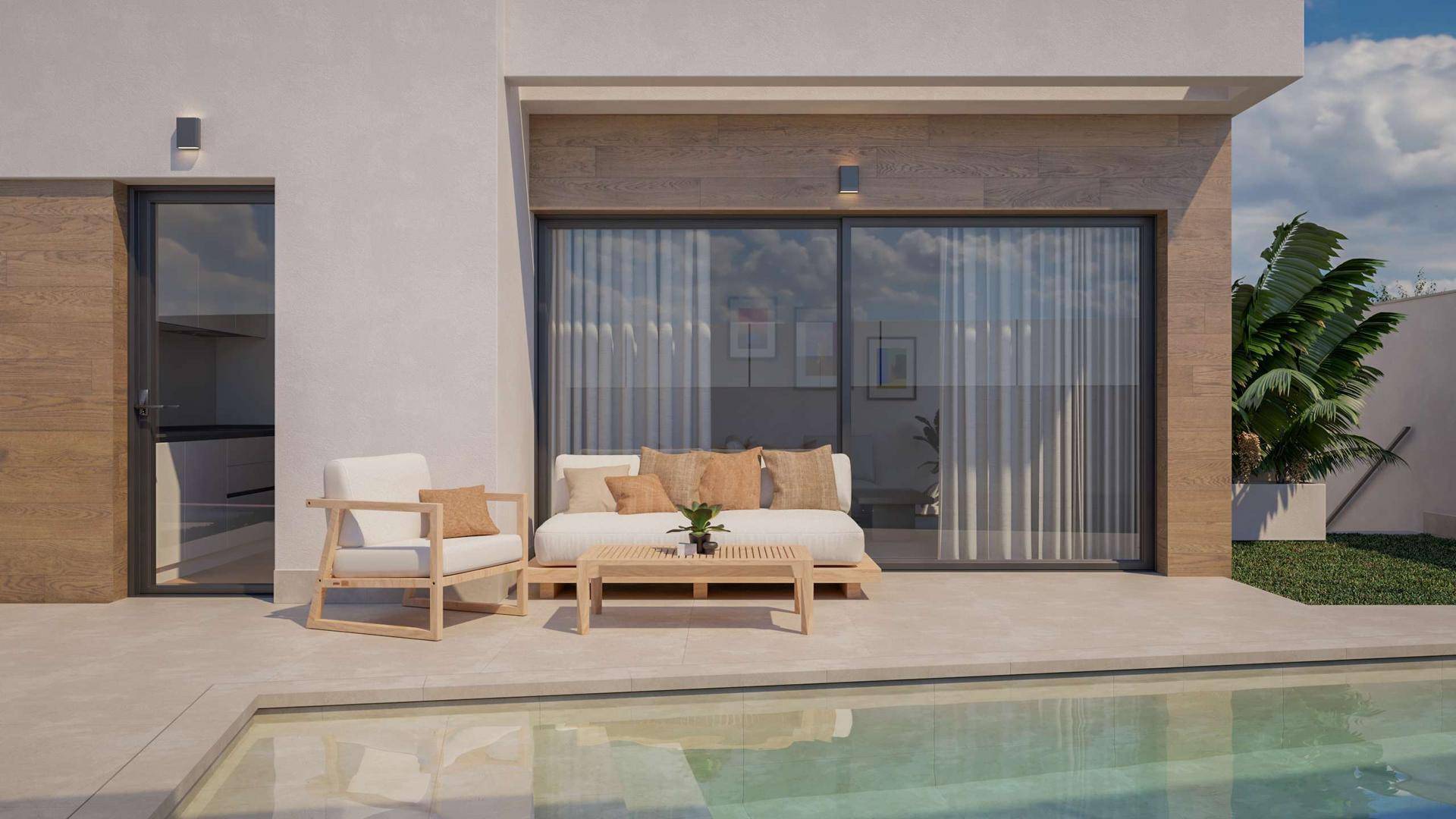 Gemütlicher Außenbereich mit Sitzgelegenheiten und direktem Zugang zum Pool und Haus.