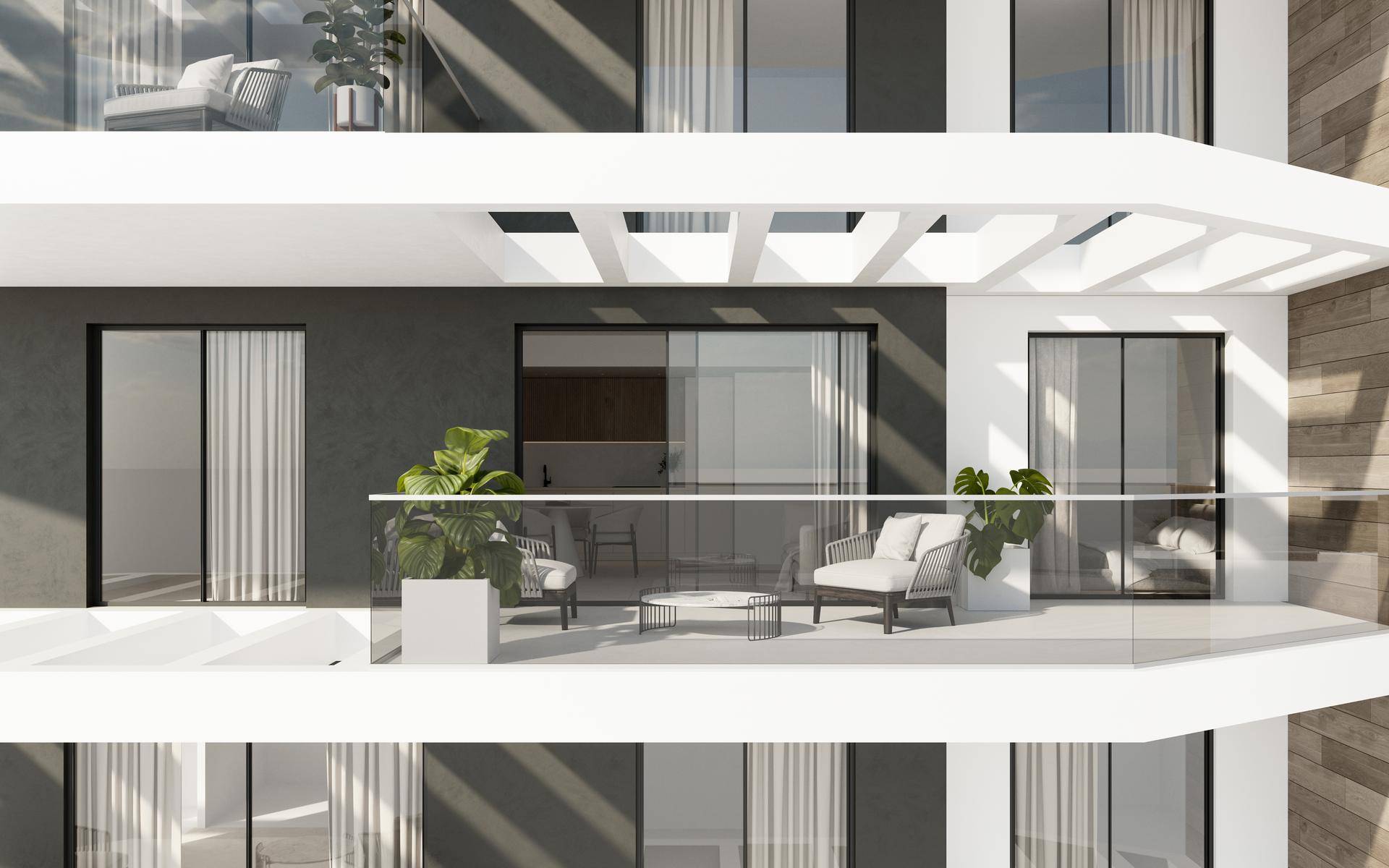 Moderne Balkone mit Glasgeländern und eleganten Außenmöbeln an der Gebäudefassade.