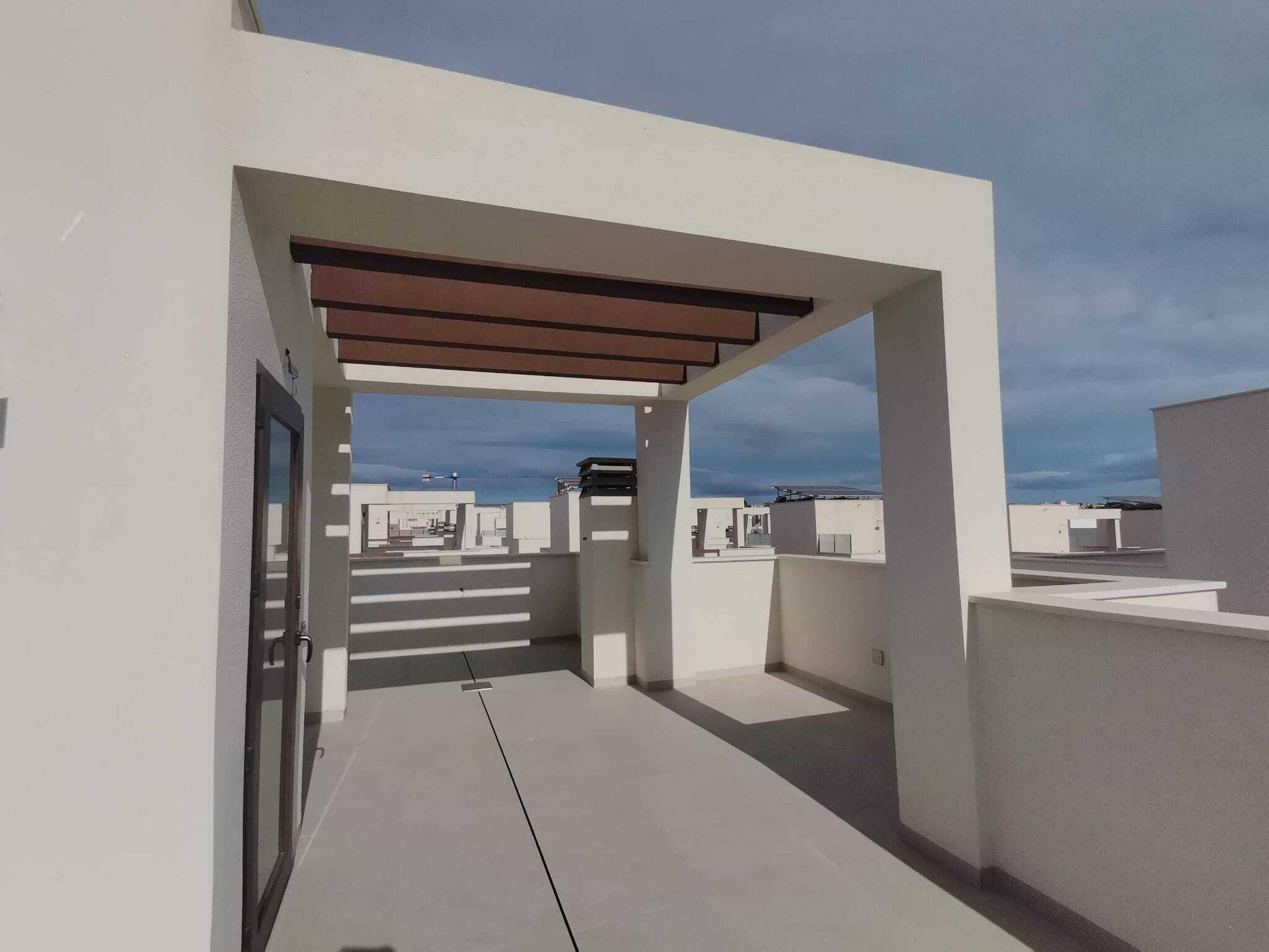 Überdachter Bereich auf der Dachterrasse mit Pergola, ideal für Schatten und Entspannung im Freien.