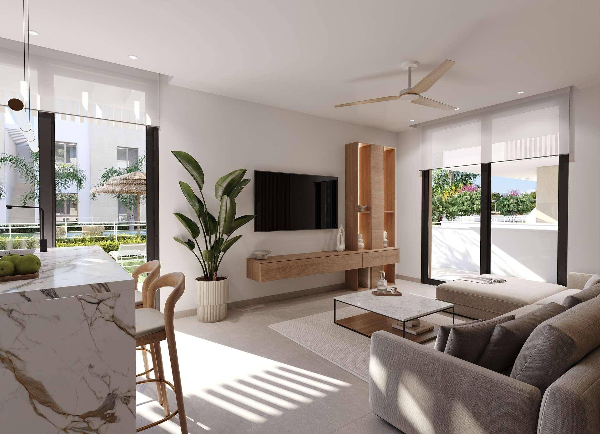 Helles, modernes Wohnzimmer mit beigem Sofa, Couchtisch und Blick auf den Außenbereich, offen zur Küche.