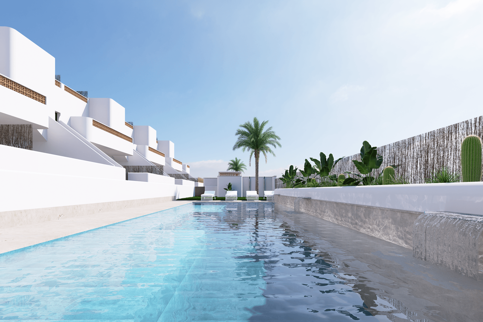 Langer Swimmingpool mit klarem Wasser und minimalistischer Gestaltung, umgeben von mediterranen Pflanzen.