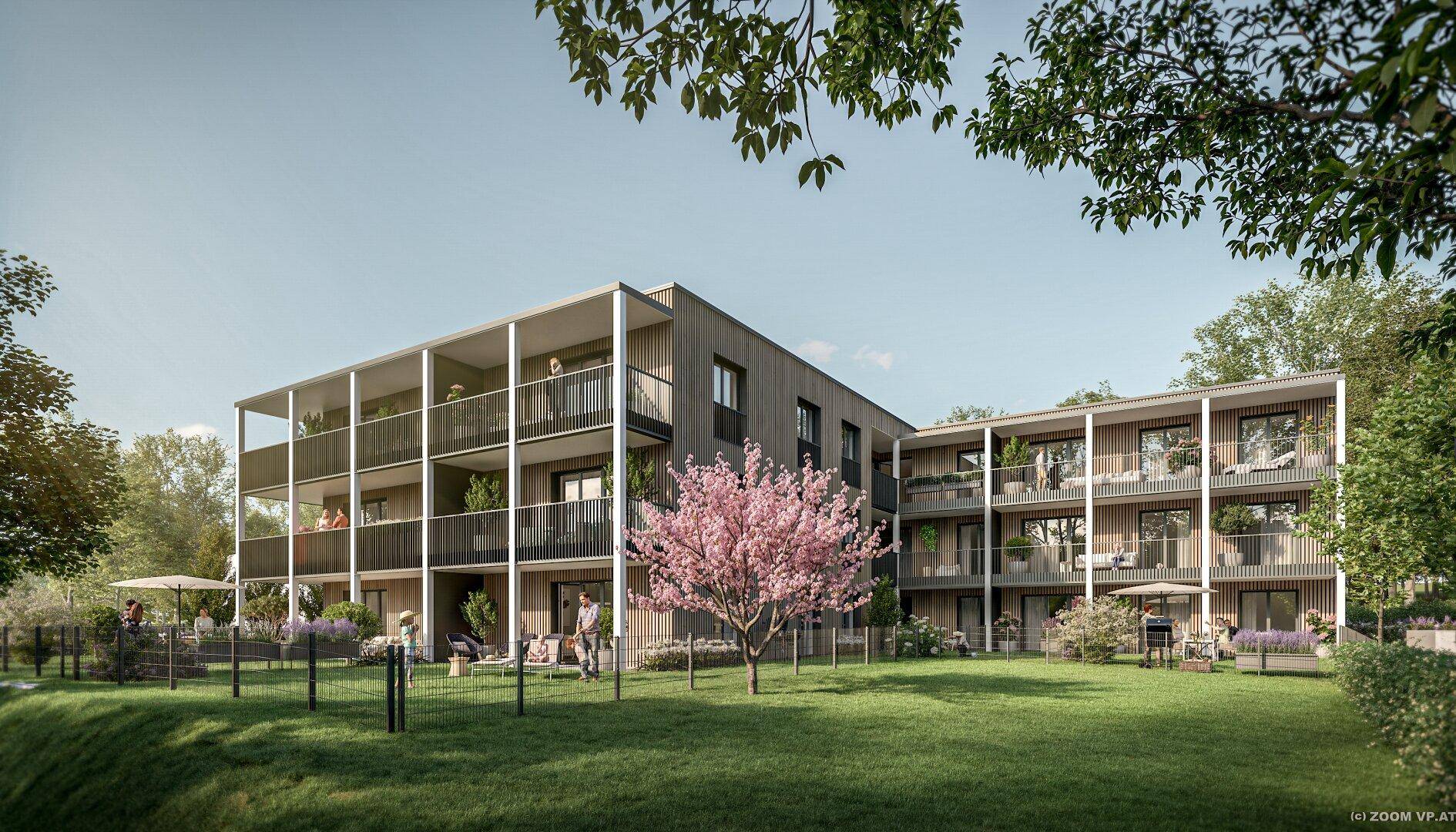 Moderne Wohnanlage mit großzügigen Balkonen und einer gepflegten Gemeinschaftsgartenanlage mit Sitzbereichen.