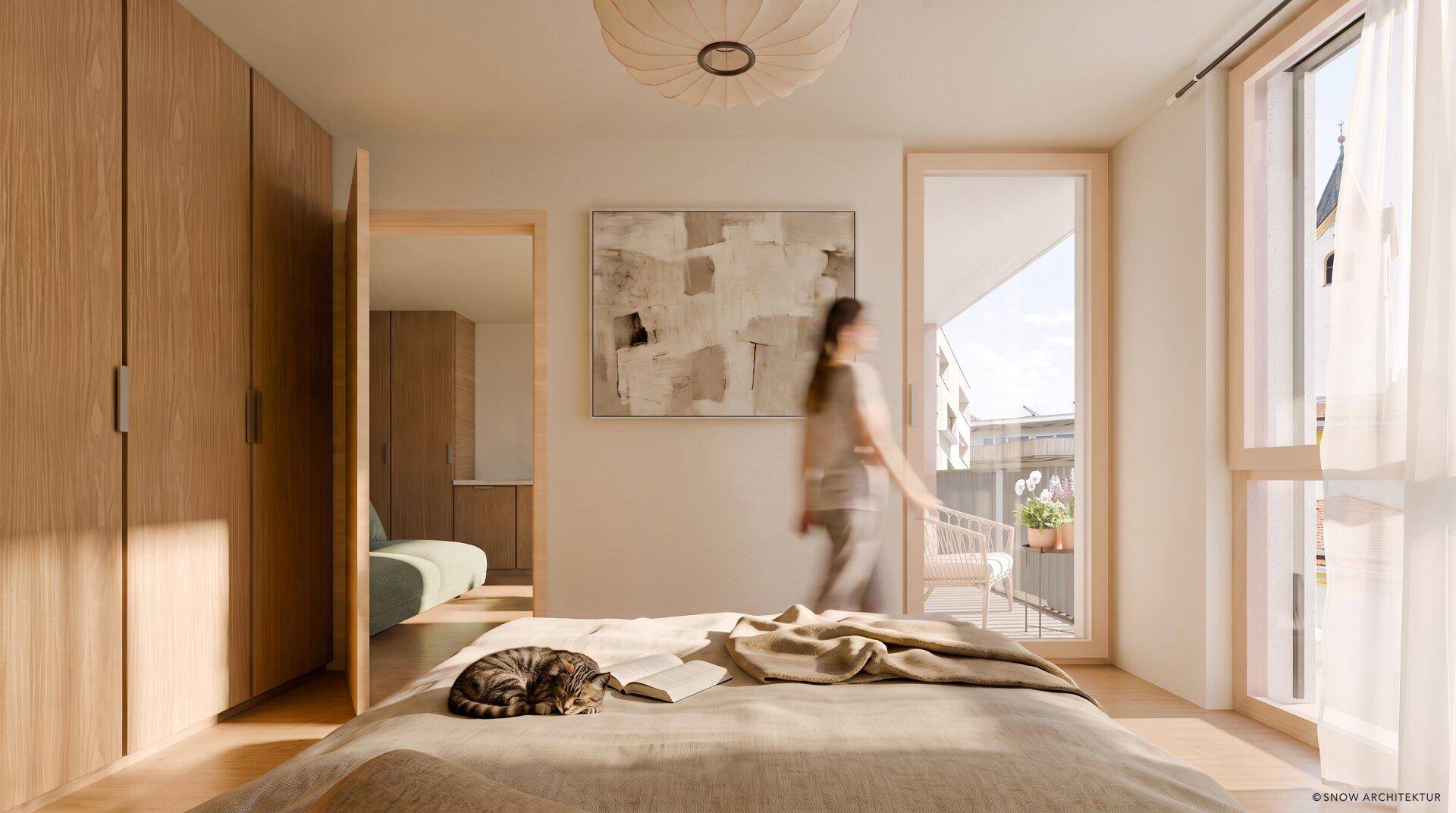Helles Schlafzimmer mit Holzeinbauschränken, gemütlichem Bett und Zugang zu einem kleinen Balkon.