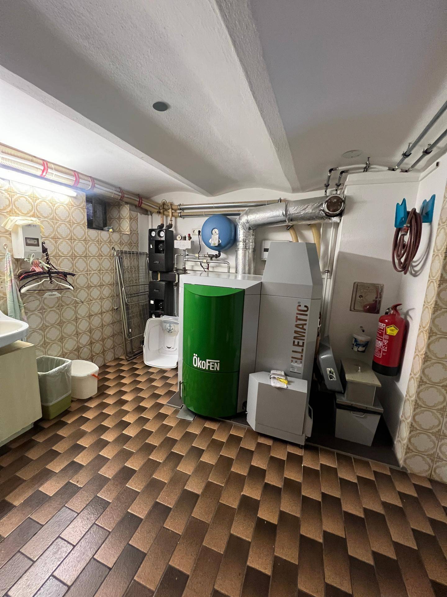Heizungsraum mit moderner Pelletheizung und technischen Installationen.