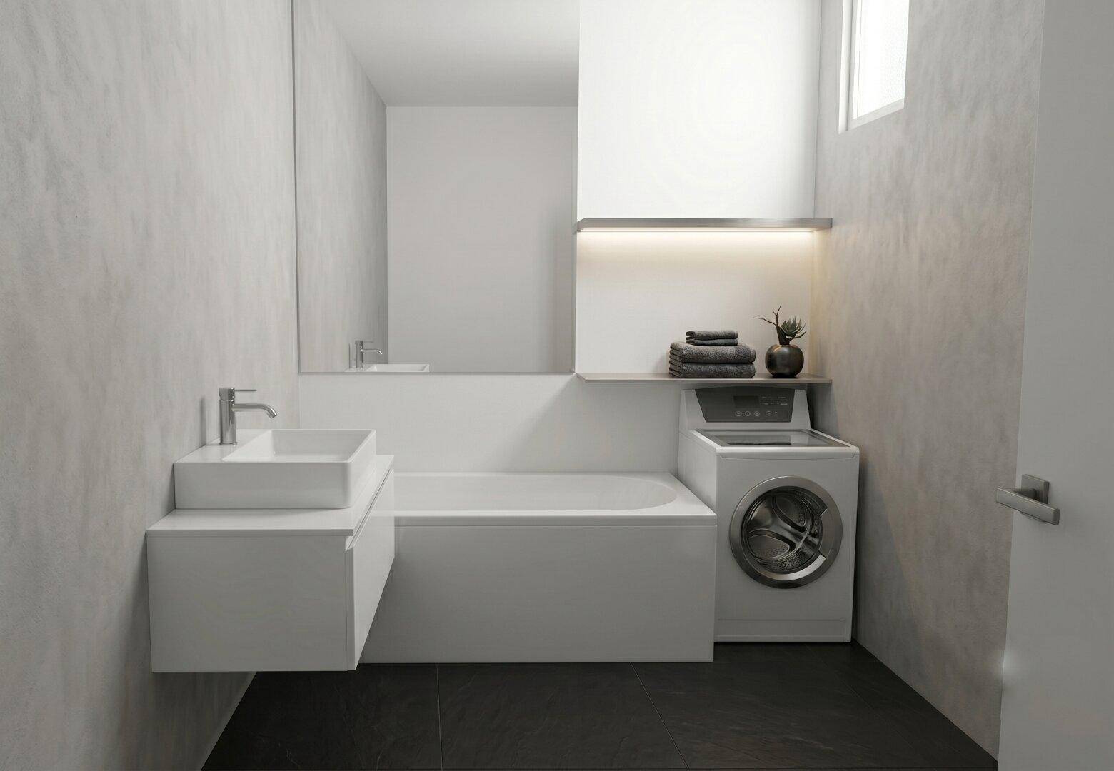 Modernes Badezimmer mit Badewanne, Waschbecken und integrierter Waschmaschine.
