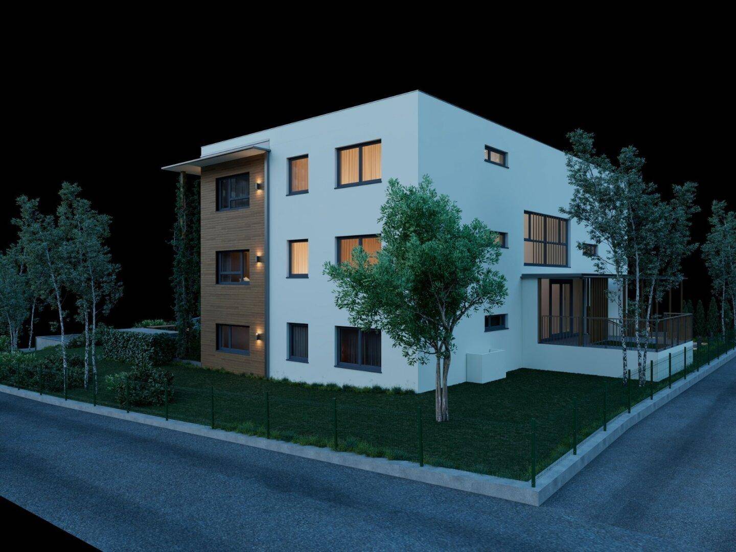 Nachtansicht eines modernen Gebäudes mit weißer Fassade, großen Fenstern und umgebender Grünfläche.