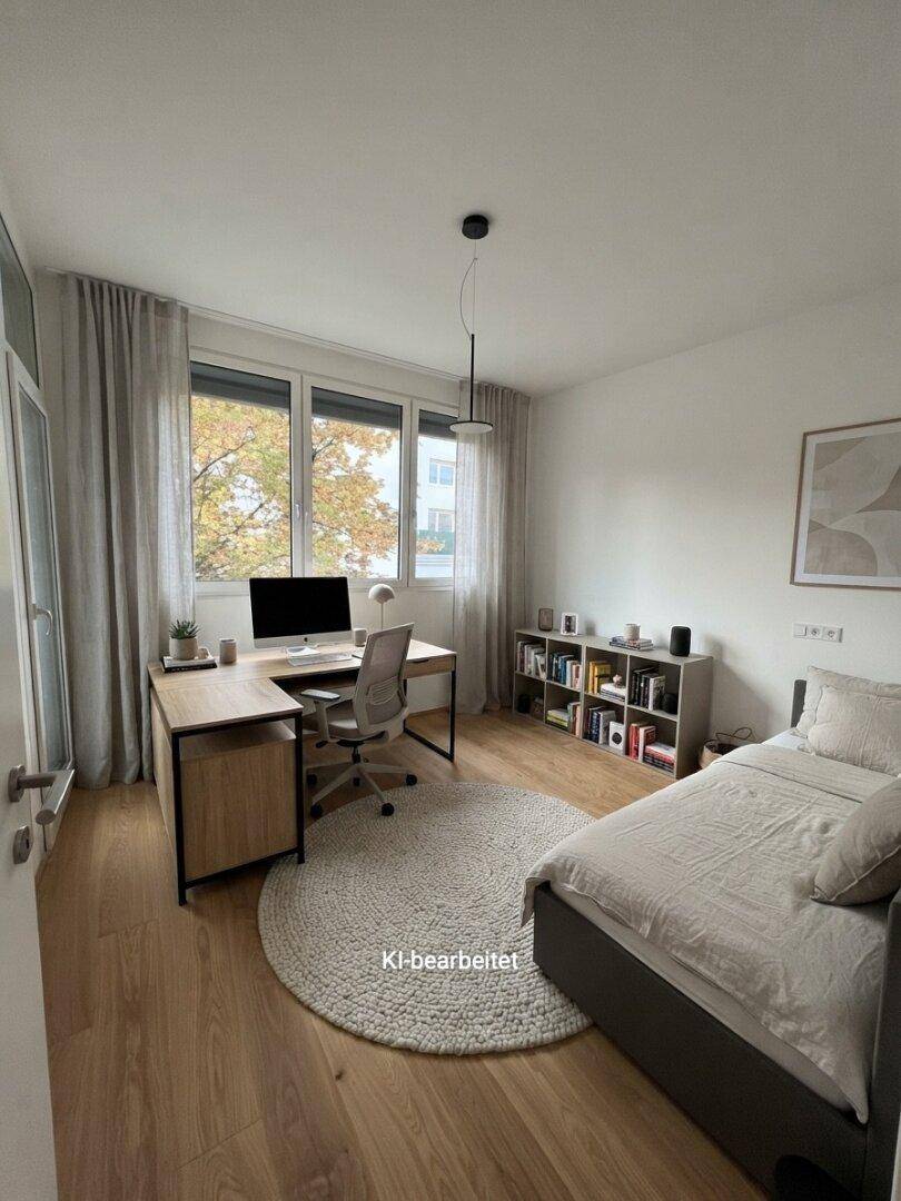 Modern eingerichtetes Schlafzimmer mit Schreibtisch, Holzboden und Blick ins Grüne.