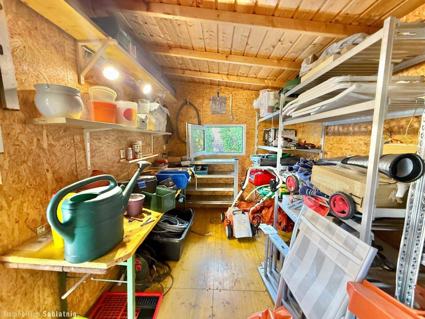 Geräumiger Gartenschuppen mit Regalen und Stauraum für Gartengeräte und Werkzeuge.