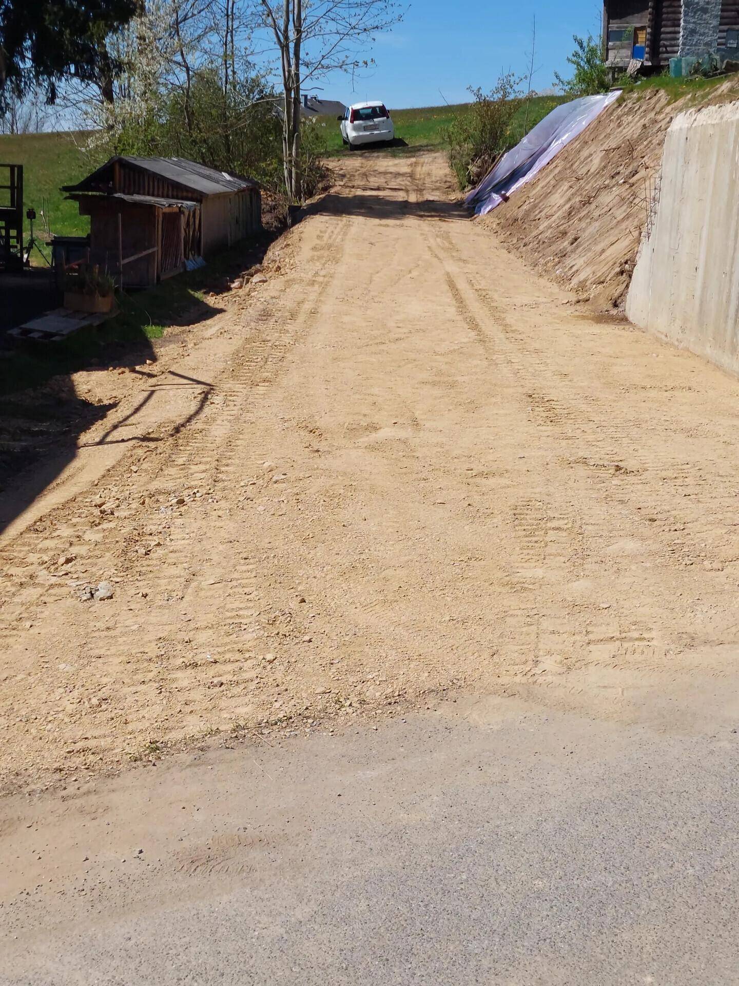 Unbefestigte Zufahrt oder Weg, der zu einem höher gelegenen Bereich mit einem Fahrzeug führt.