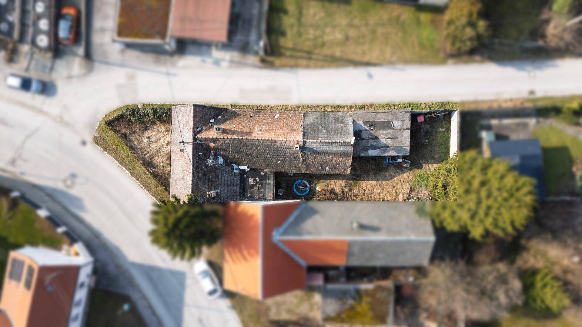 Luftbild von oben zeigt die Dachflächen des Hauses und die Grundstücksgrenzen.