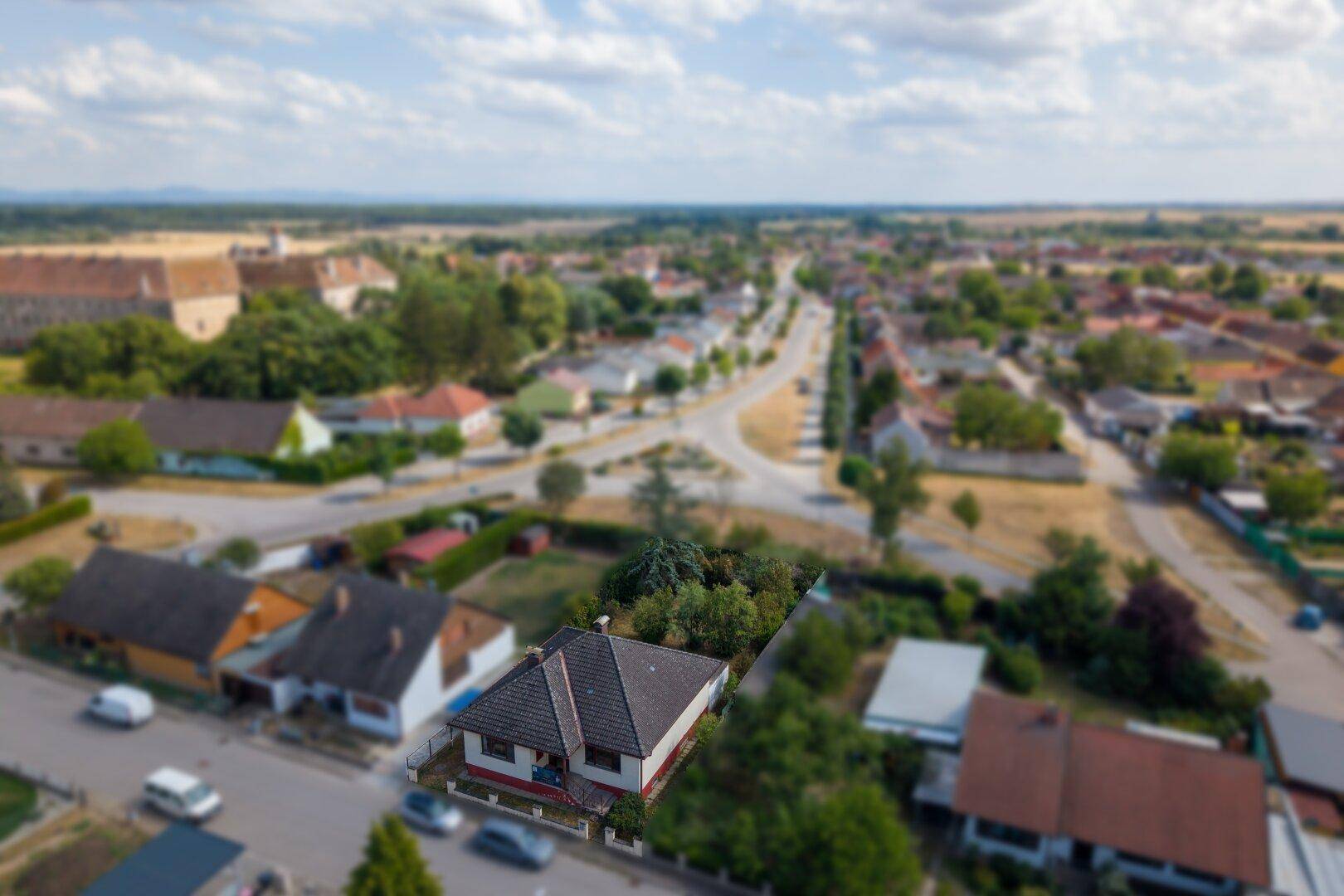 Panoramablick aus der Luft auf das Wohnhaus und die weite, grüne Umgebung mit Feldern.