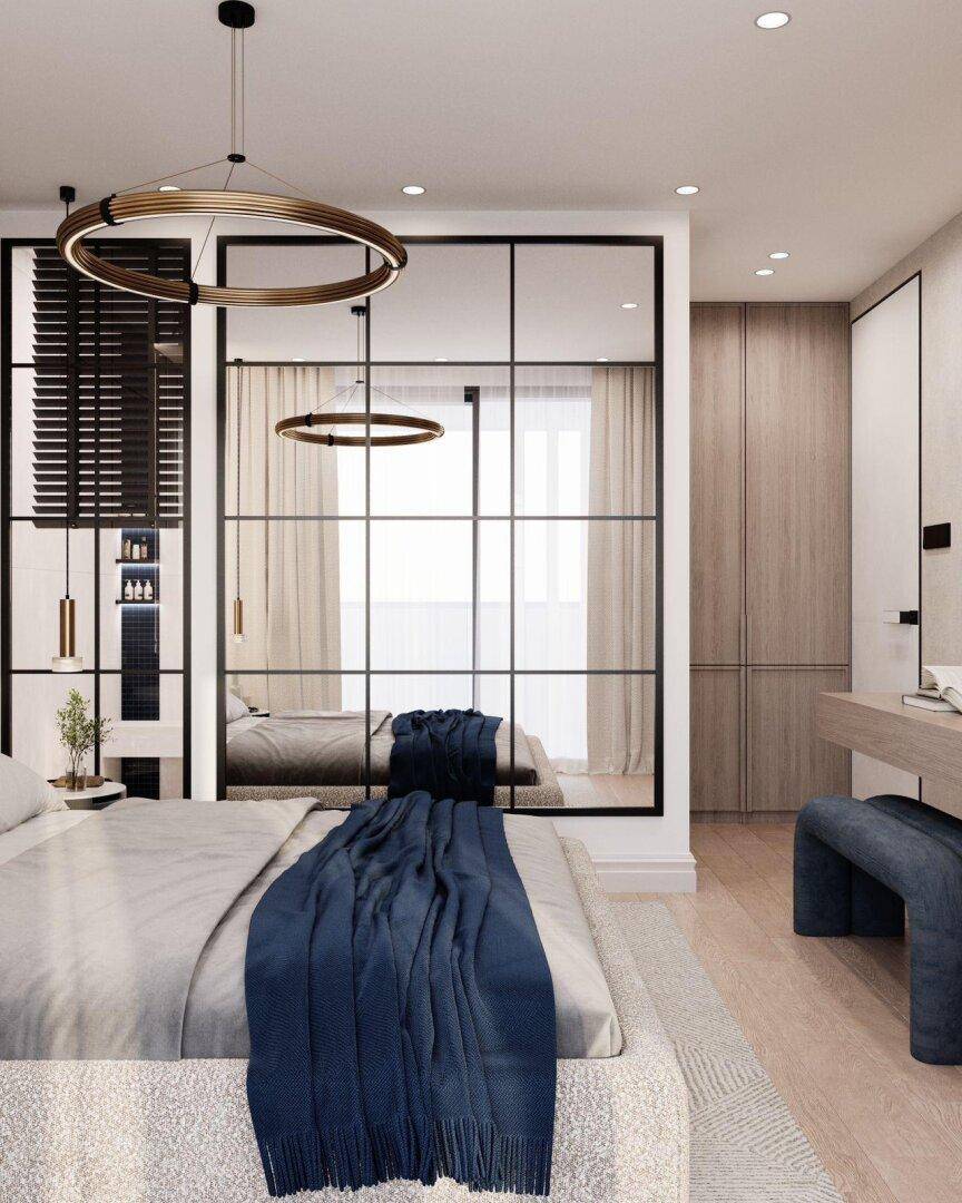 Helles Schlafzimmer mit großem Bett, Spiegelfronten und modernen Hängeleuchten.