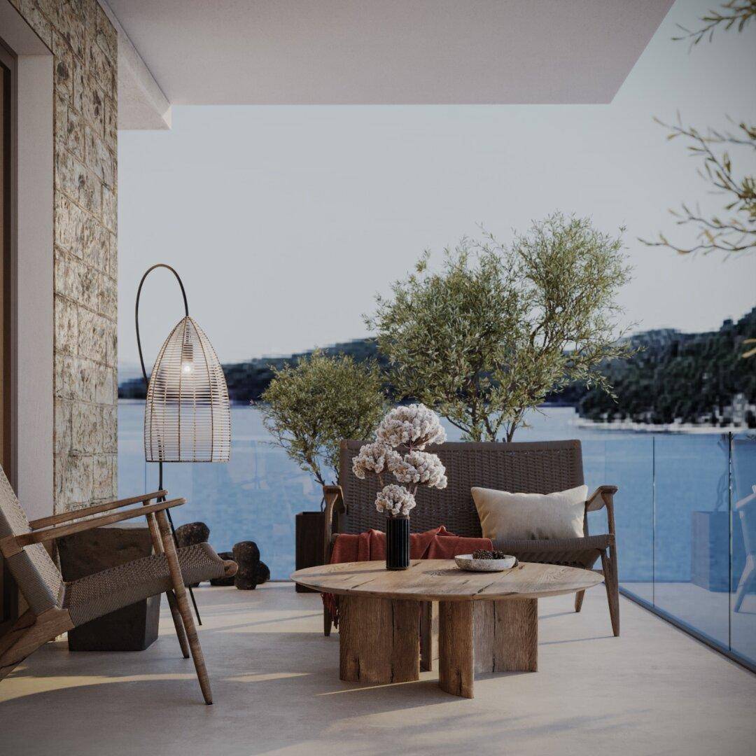 Gemütlicher Balkon mit Sitzgelegenheiten, Meerblick und moderner Dekoration.