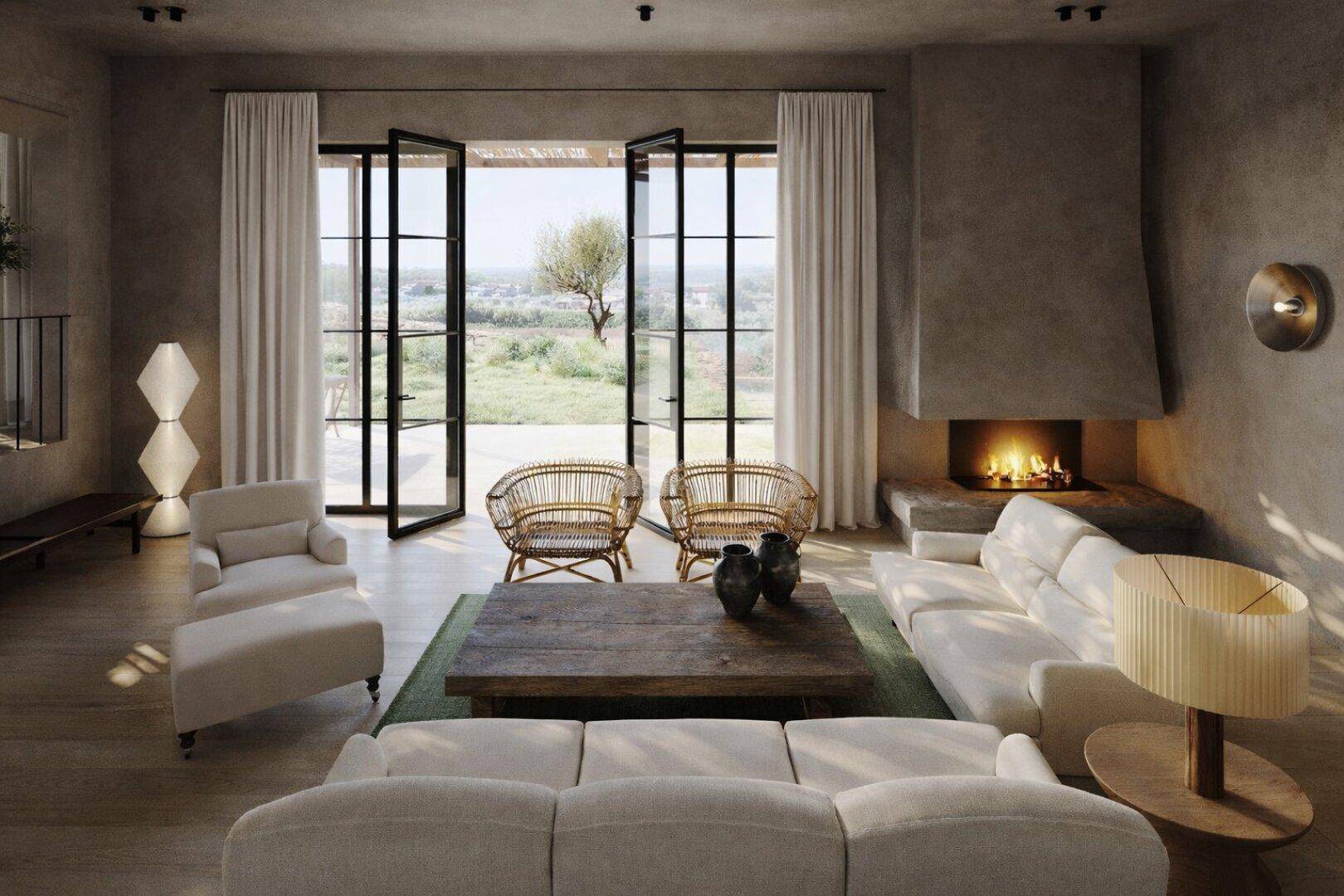 Helles Wohnzimmer mit Kamin, bequemen Sofas und Zugang zur Terrasse mit Landschaftsblick.