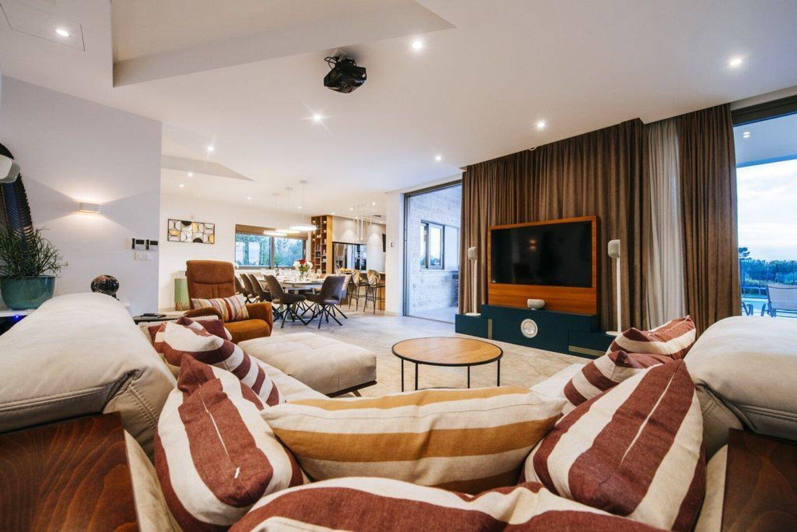 Komfortables Wohnzimmer mit Blick auf den Essbereich und die Küche, ideal für geselliges Beisammensein.